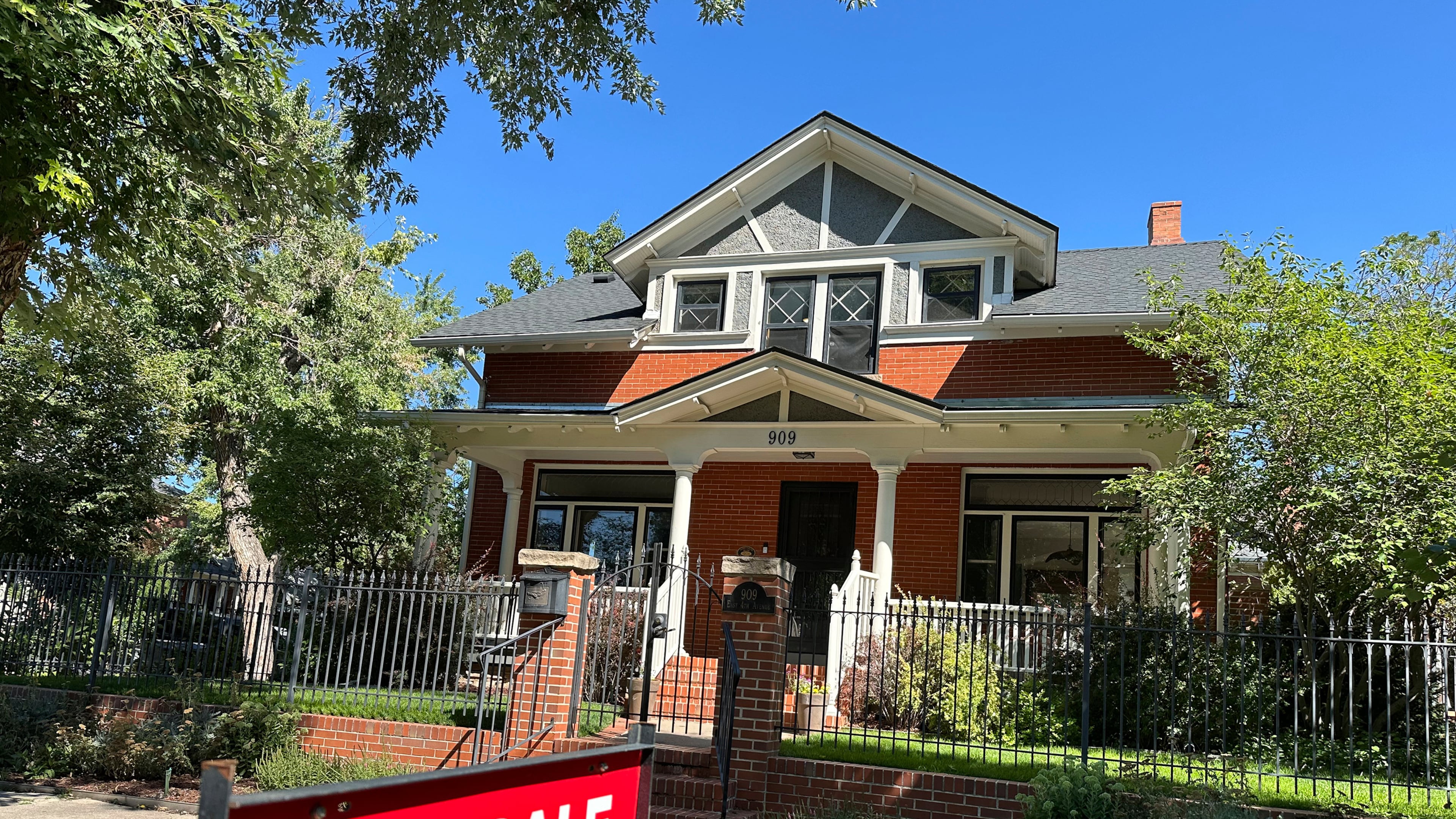 FILE - A for sale sign stands outside a home on the market in the Alamo Placita neighborhood Tuesday, Aug. 27, 2024, in central Denver. (AP Photo/David Zalubowski, File)