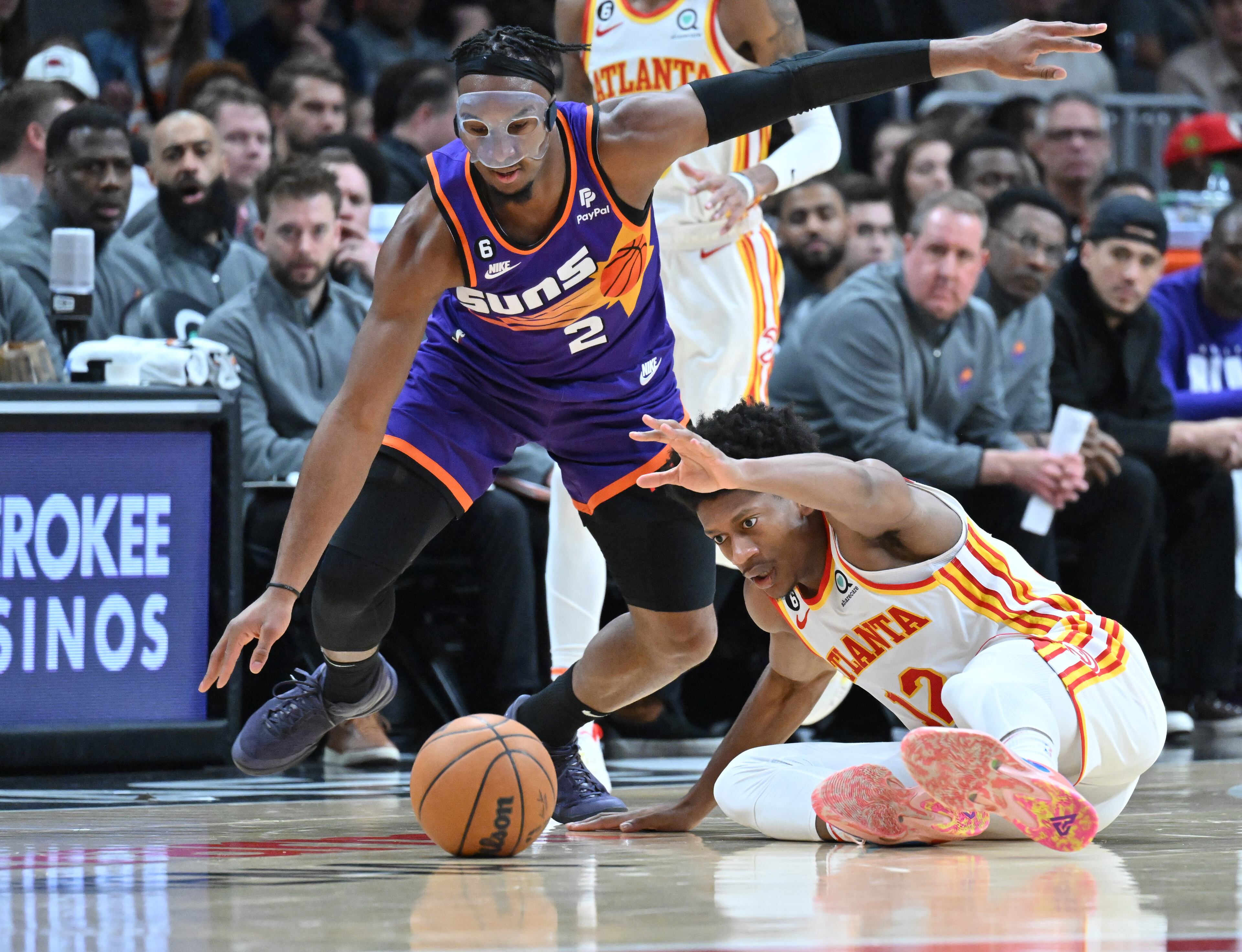 Atlanta Hawks' forward De'Andre Hunter (12) and Phoenix Suns' forward Josh Okogie (2) battle for a loose ball during the second half in an NBA basketball game at State Farm Arena, Thursday, Feb. 9, 2023, in Atlanta. (Hyosub Shin / Hyosub.Shin@ajc.com)