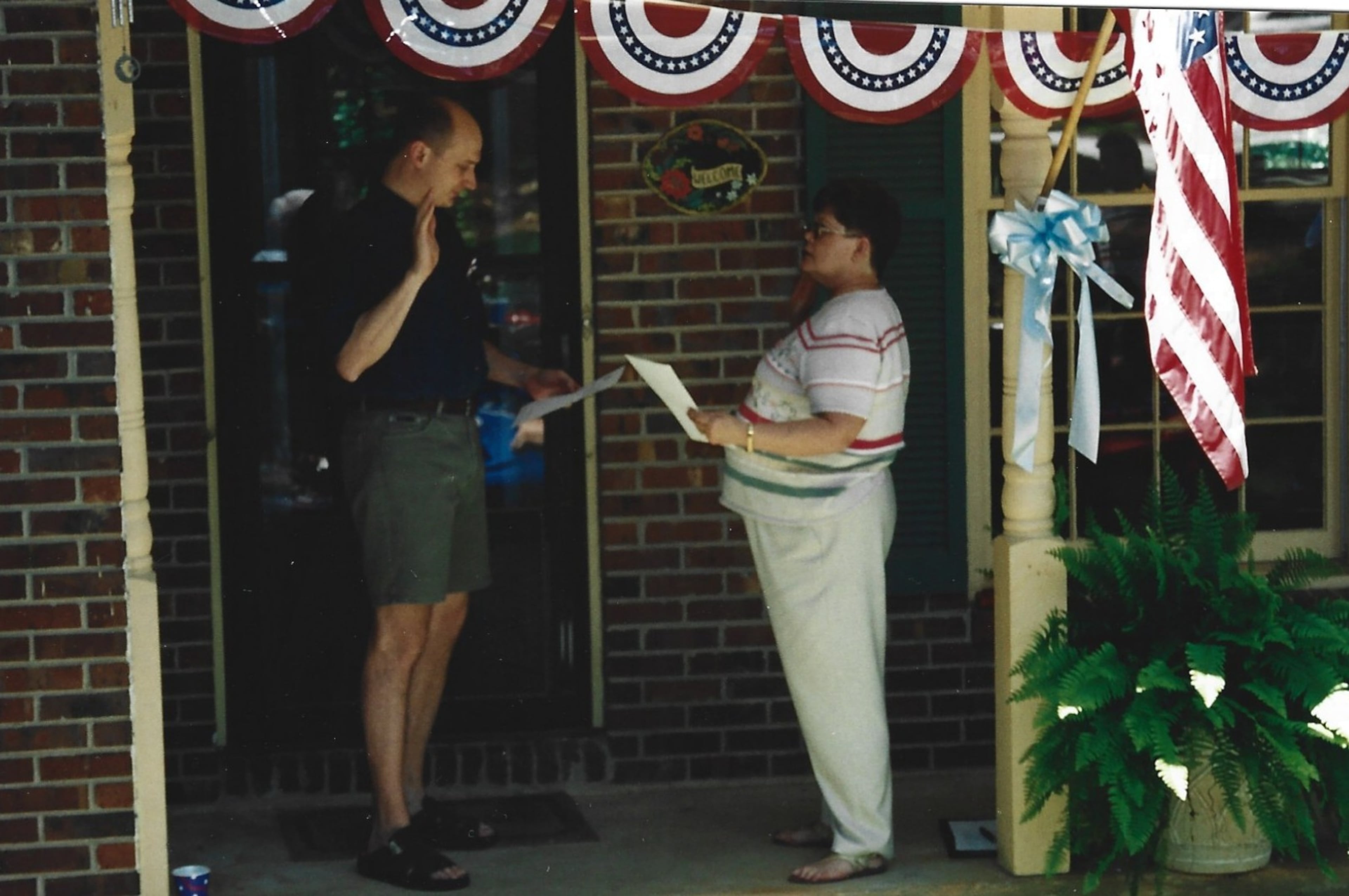 Steve is sworn as an American citizen on the front porch of his first home in the United States in 2003. (Courtesy of Steve Leo)