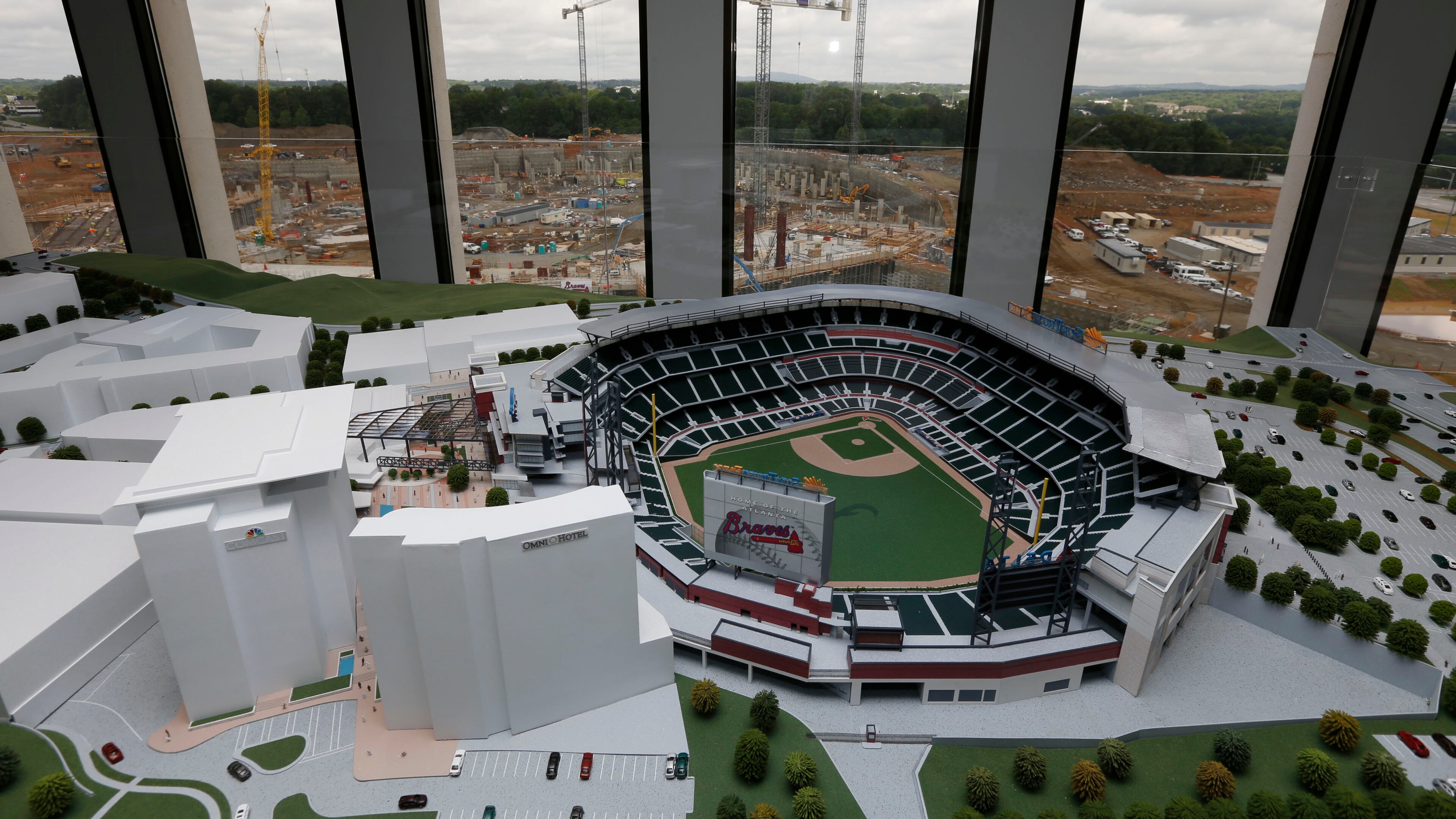 May 27, 2015 - Cobb County - A scale model of SunTrust Park sits in the window across from stadium construction. BOB ANDRES / BANDRES@AJC.COM