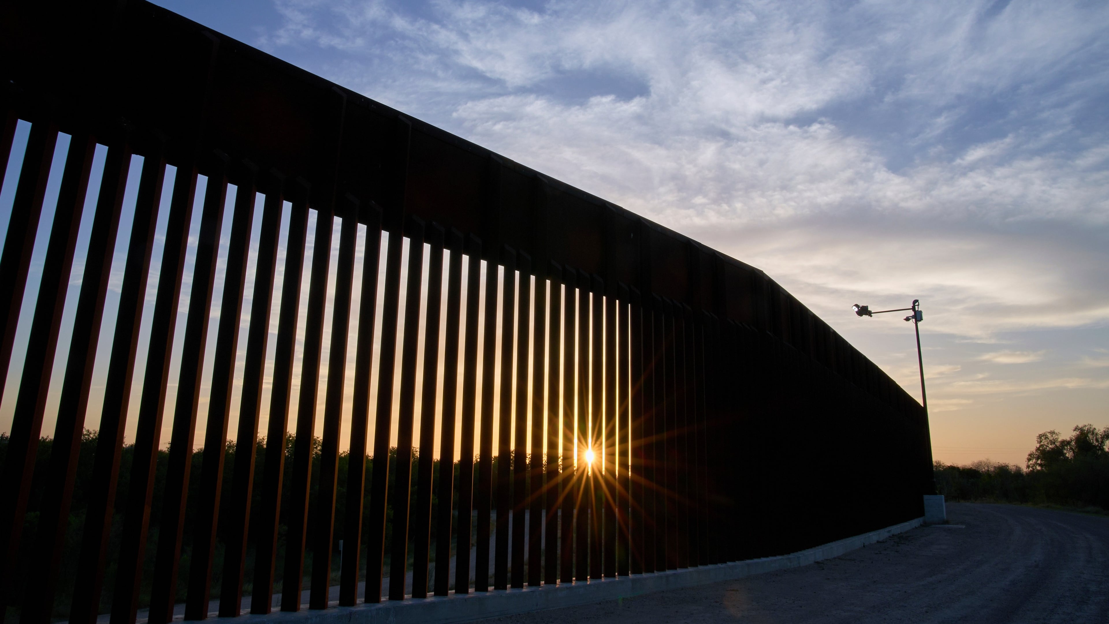 FILE - The sun sets over a section of the border wall, June 18, 2025, in Mission, Texas. (AP Photo/Jacquelyn Martin, File)