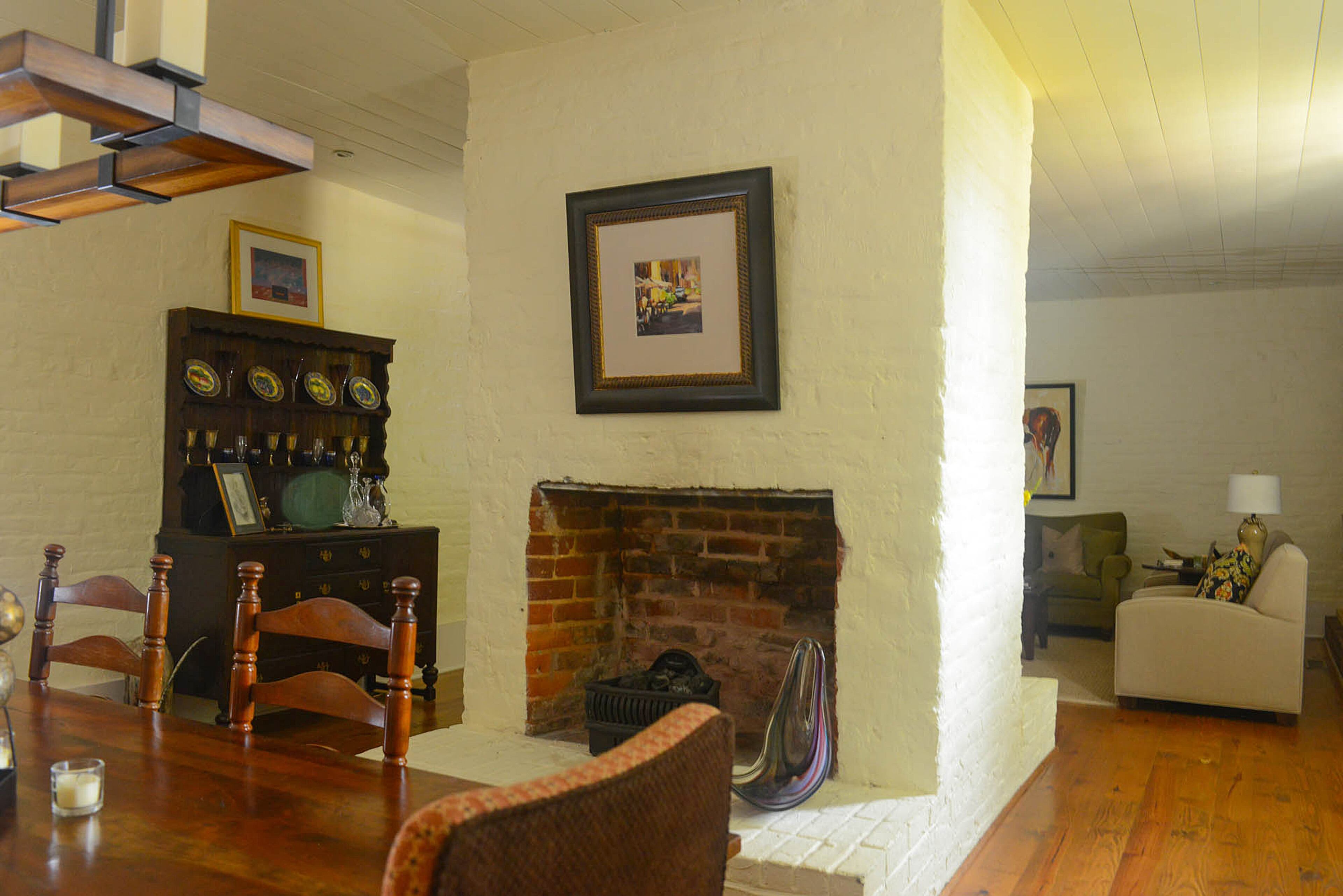 At one point, a thick brick wall split the dining room and sitting room in the Roswell home, which was built in 1839 and originally part of a mill village community called "The Old Bricks." Today, a double-sided fireplace pays homage to its historic roots as a divider between the two rooms.