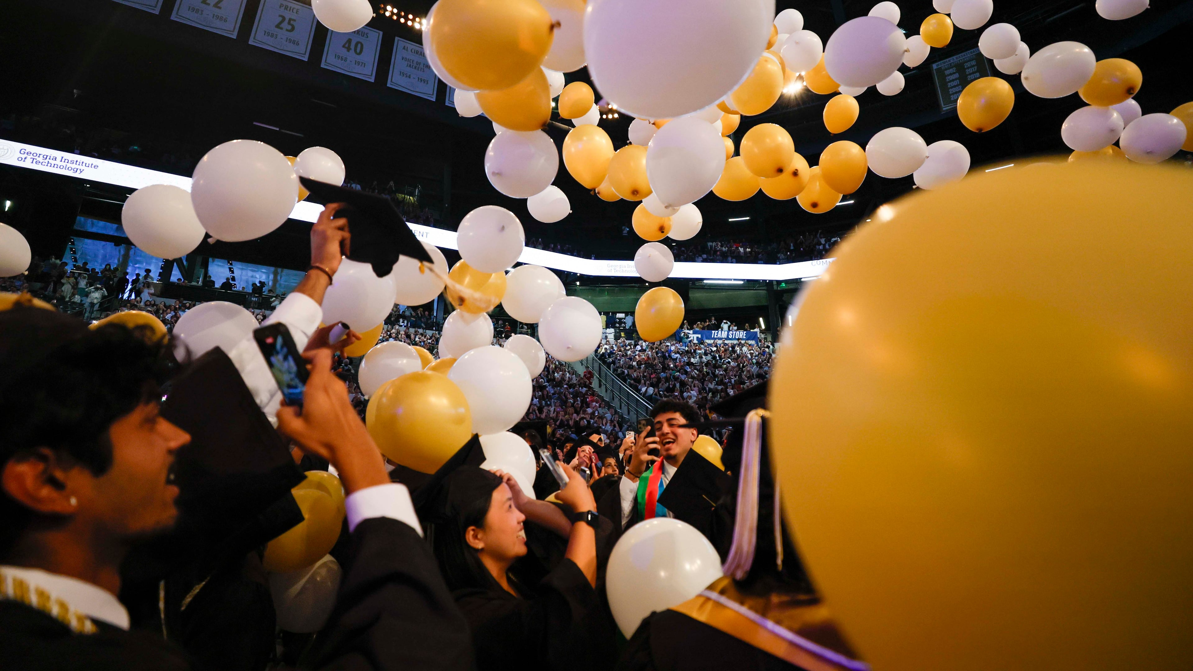 Georgia Tech graduates celebrate at the end of their commencement ceremony at the McCamish Pavilion on Thursday, May 7, 2026, in Atlanta. Universities across the state are increasingly offering more AI classes in hopes of preparing students for a changing job market. (Miguel Martinez/AJC)
