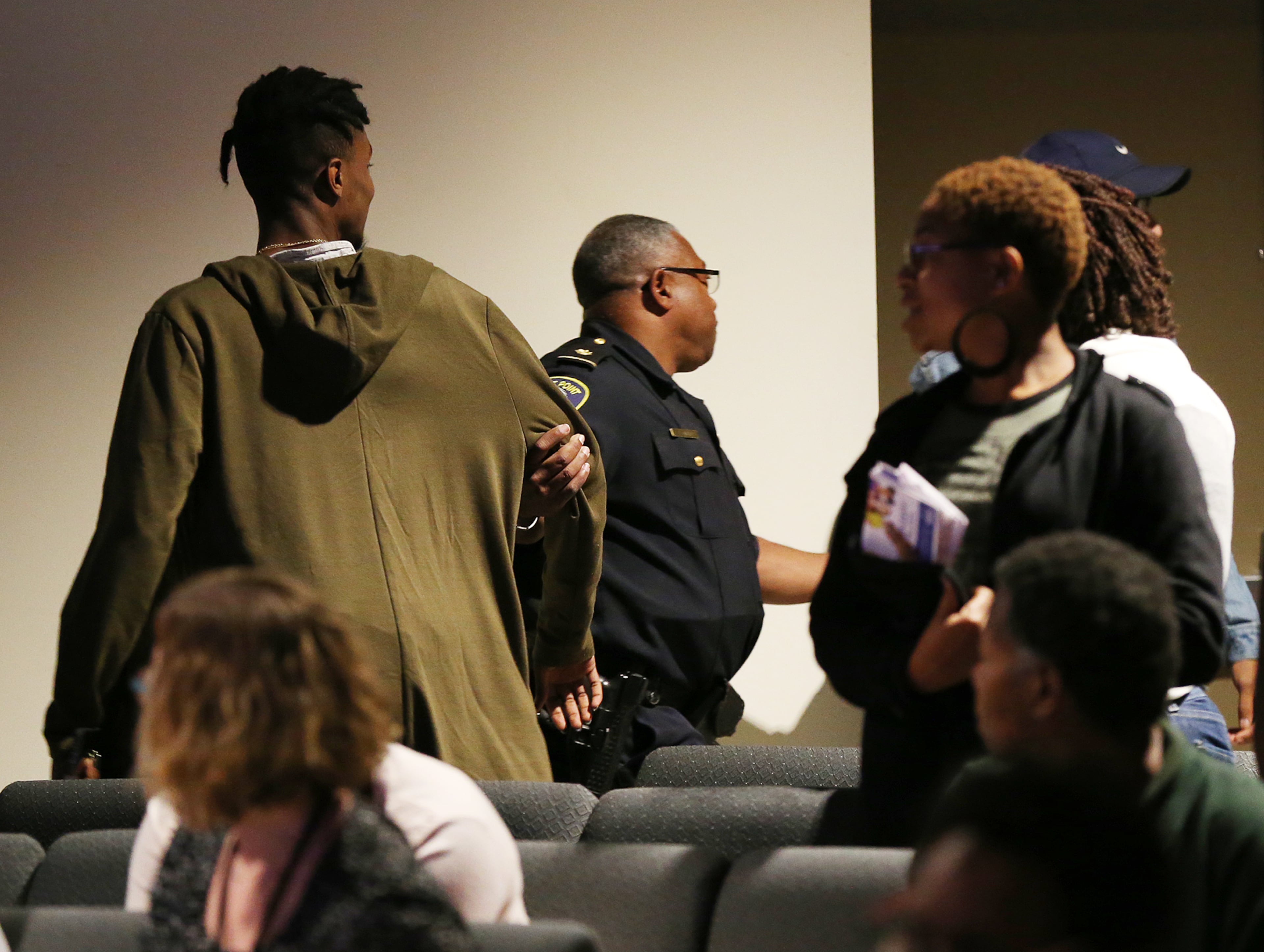 An East Point police officer removes a pair of hecklers shouting "No OSD" while Gov. Nathan Deal concludes a discussion on the Opportunity School District referendum at Impact Church on Tuesday, Oct. 25, 2016, in East Point. Curtis Compton /ccompton@ajc.com