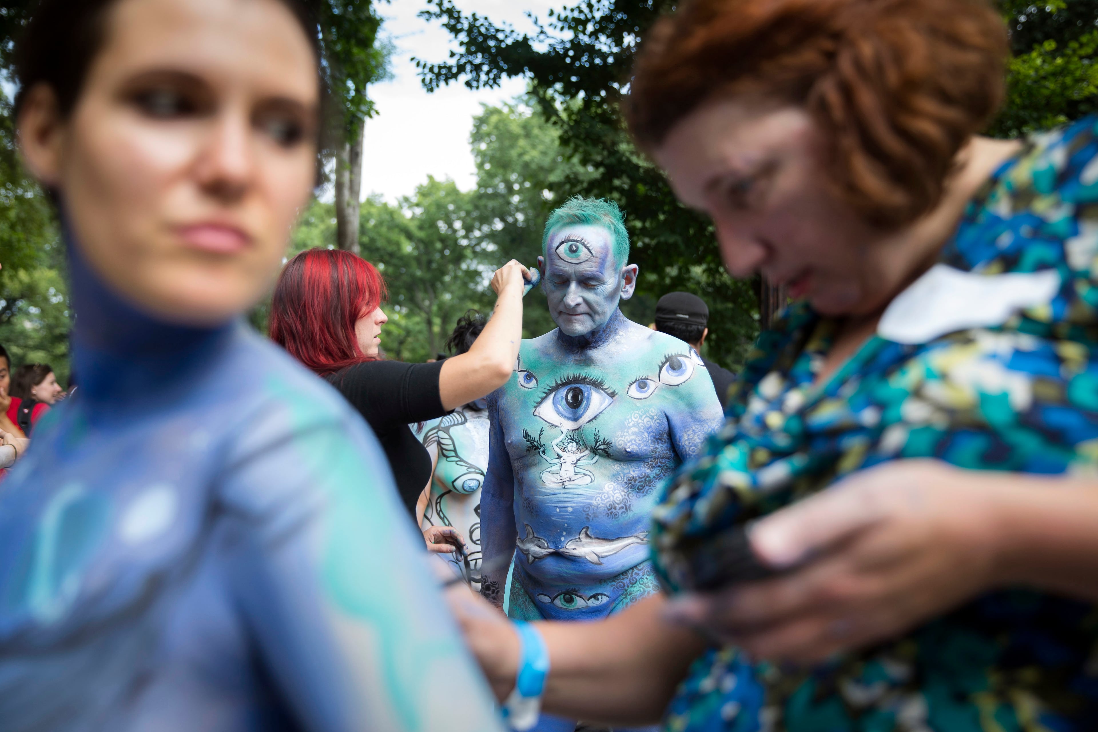 Jack van Riper, of New Jersey, is painted at Columbus Circle as body-painting artists gathered to decorate nude models as part of an event featuring artist Andy Golub, Saturday, July 26, 2014, in New York. Golub's event Saturday included a post-painting march down Broadway and a return to Times Square for a photo shoot. (AP Photo/John Minchillo)
