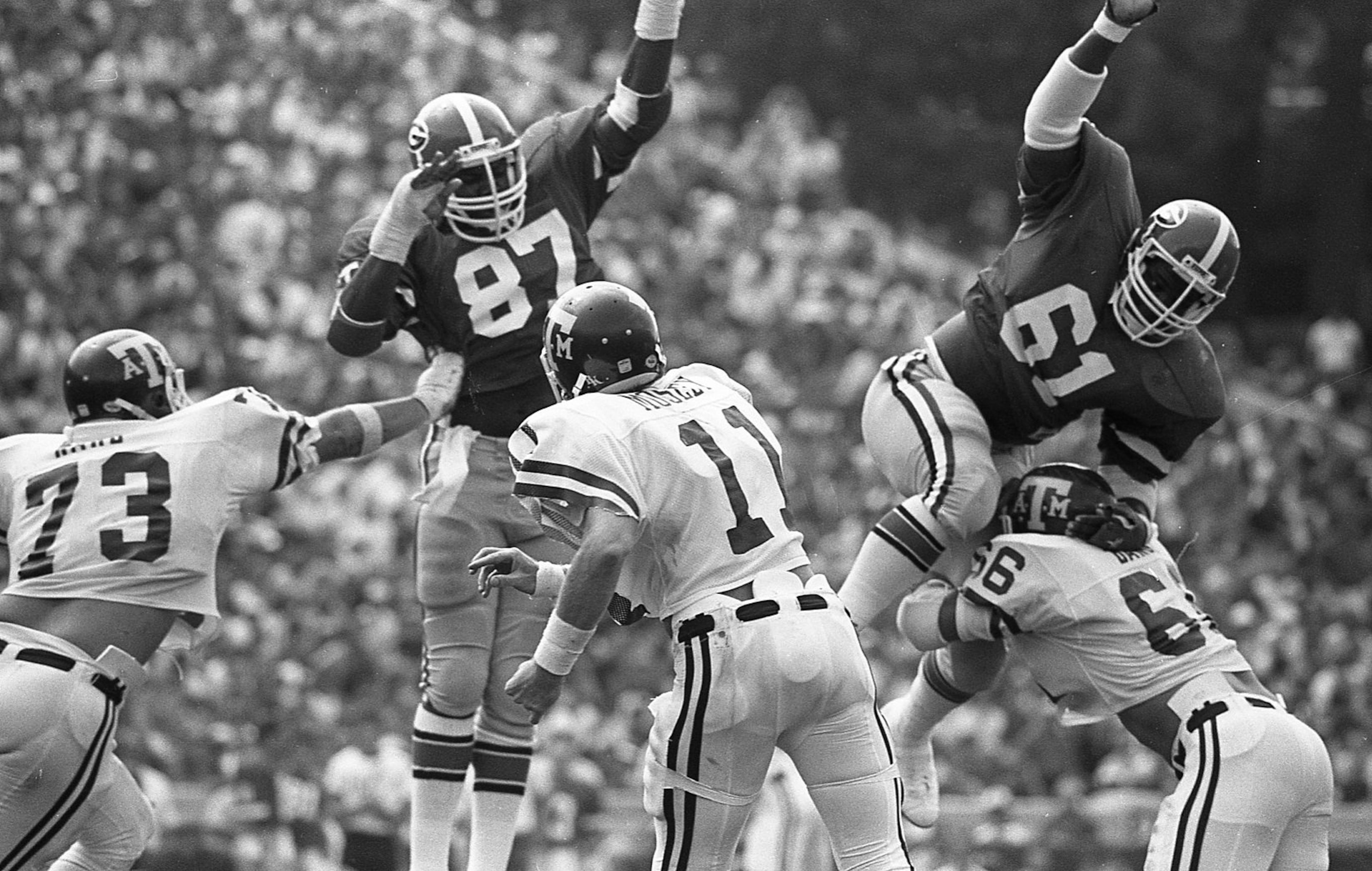Georgia Bulldogs defensive linemen Jimmy Payne (87) and Eddie Weaver (61) in action against Texas A&M at Sanford Stadium on Sept. 13, 1980. (AJC file photo)