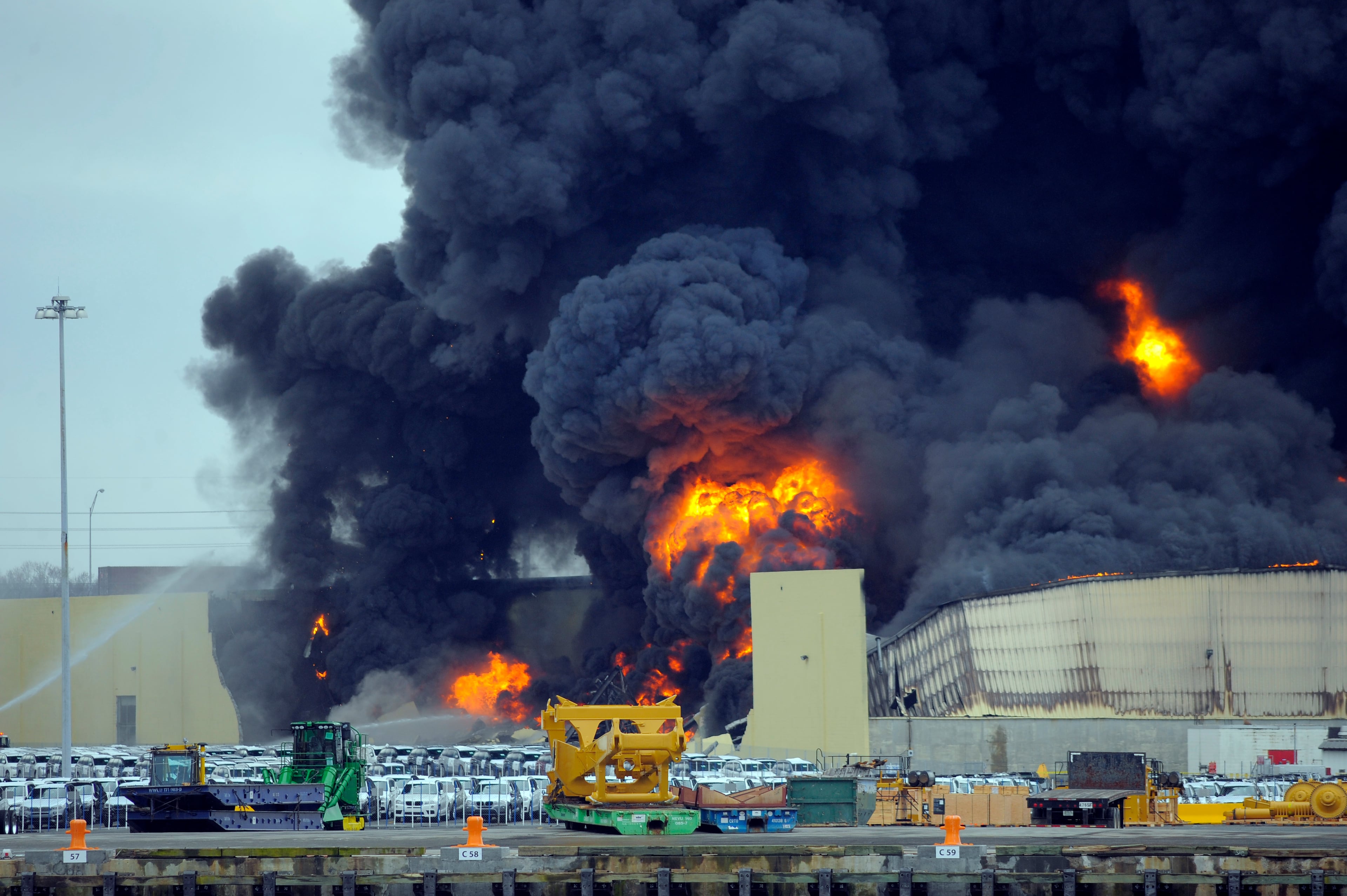 Firefighters battle a blaze in a warehouse at the Georgia Ports Authority Ocean Terminal in Savannah, Ga. on Saturday, Feb. 8, 2014. A Georgia Ports Authority spokesman said all port workers were safe and accounted for after the fire broke out. (AP Photo/Stephen B. Morton)