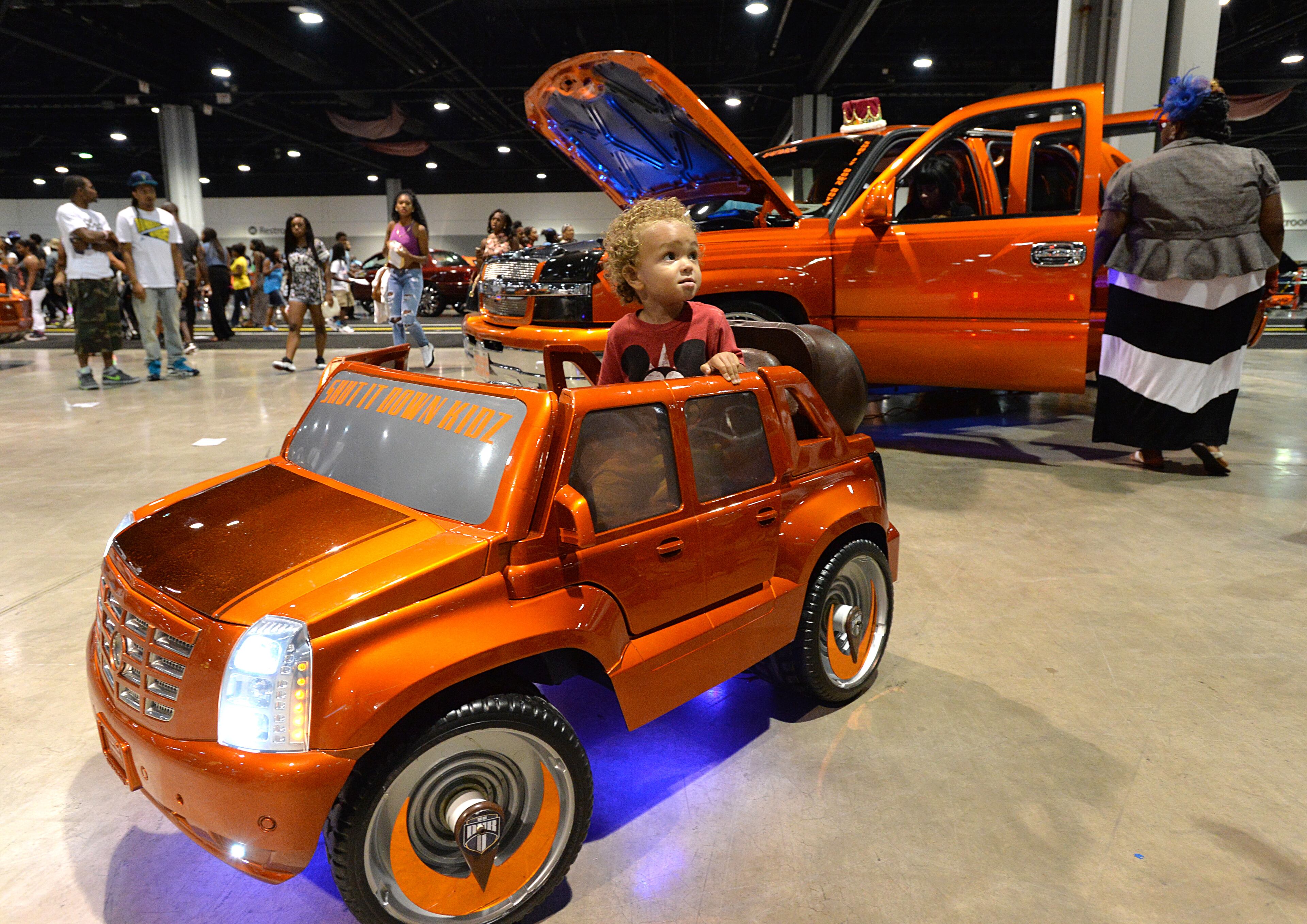 Quinton Borum Jr., 2, sits on a mini-car during The 2014 V-103/WAOK Car & Bike Show at the Georgia World Congress Center on Saturday, July 12, 2014.