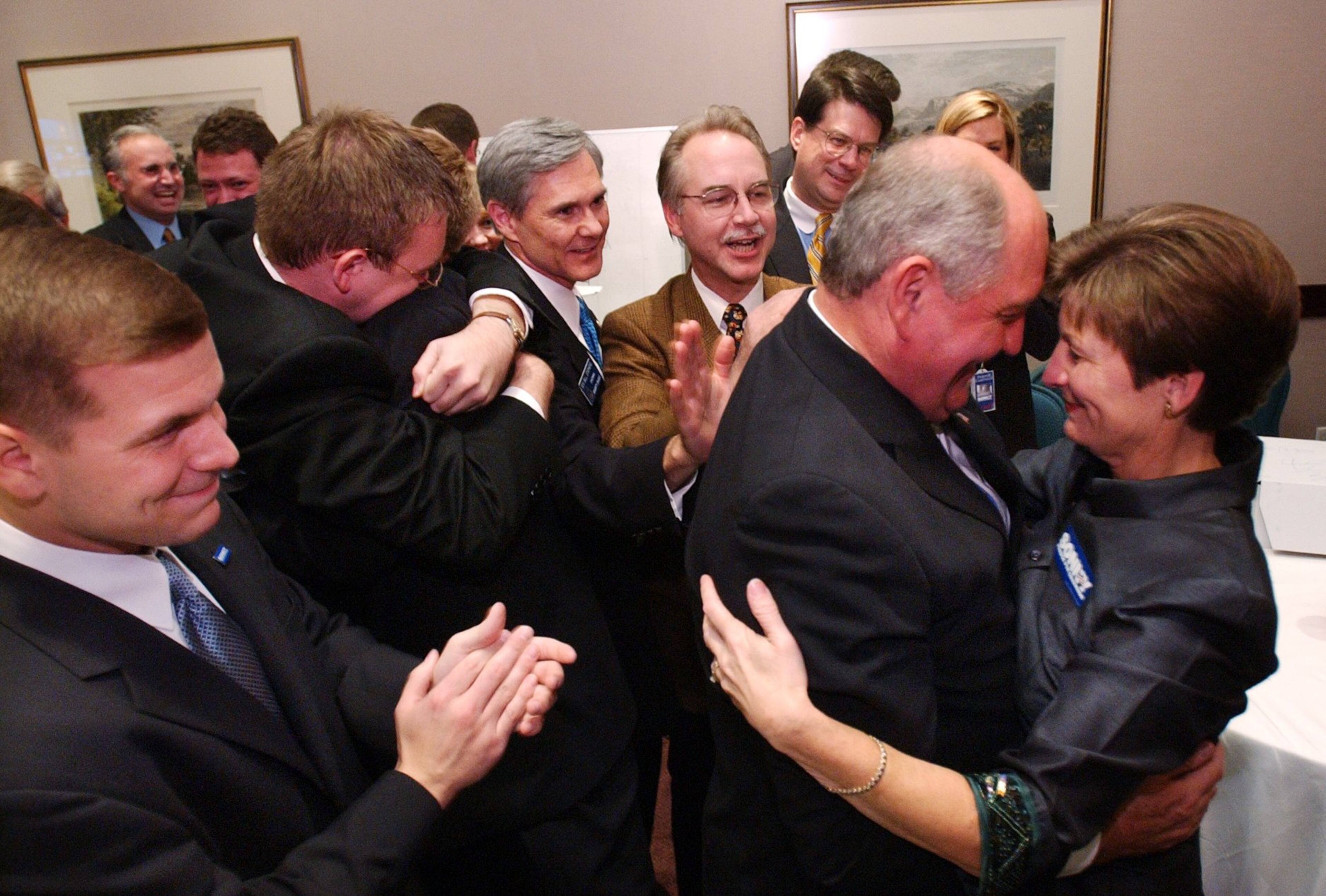 Sonny Perdue cq, the new governor of Georgia, and his wife, Mary, celebrate Perdue's victory over Roy Barnes for governor in Perdue's "war room." On the far left is son, Jim.