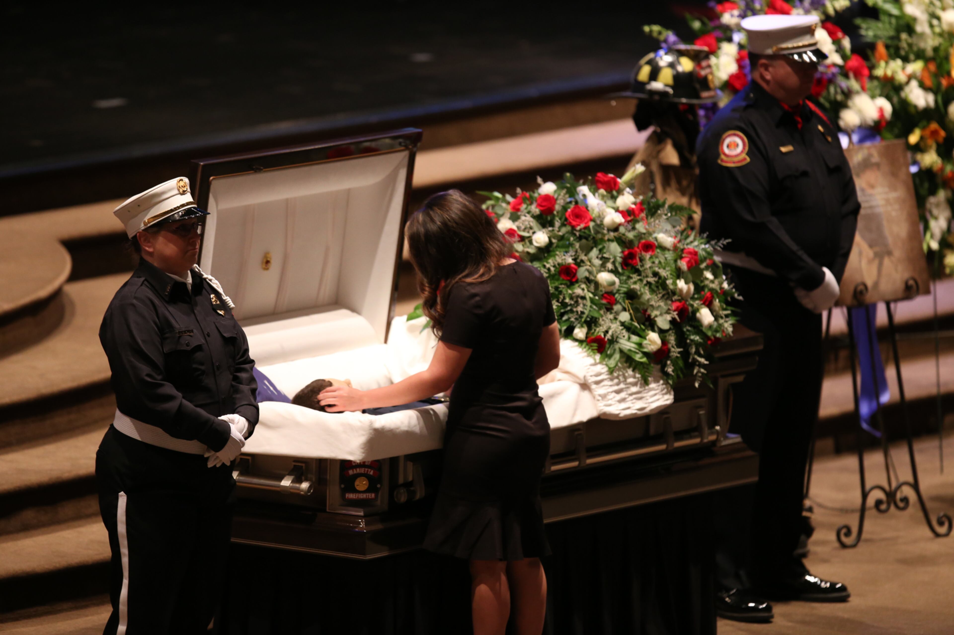PLEASE DO NOT USE THIS PHOTO IN PRINT
April 19, 2017, Atlanta, Georgia - Rosa Campos, Ron Herens' girlfriend, strokes his hair during the open casket portion of his funeral service in Powder Springs, Georgia, on April 19, 2017. A Celebration of Life funeral service was held for Marietta Fire Fighter Ron Herens, who died in a traffic accident while on vacation in Los Angeles last week. (HENRY TAYLOR / HENRY.TAYLOR@AJC.COM)