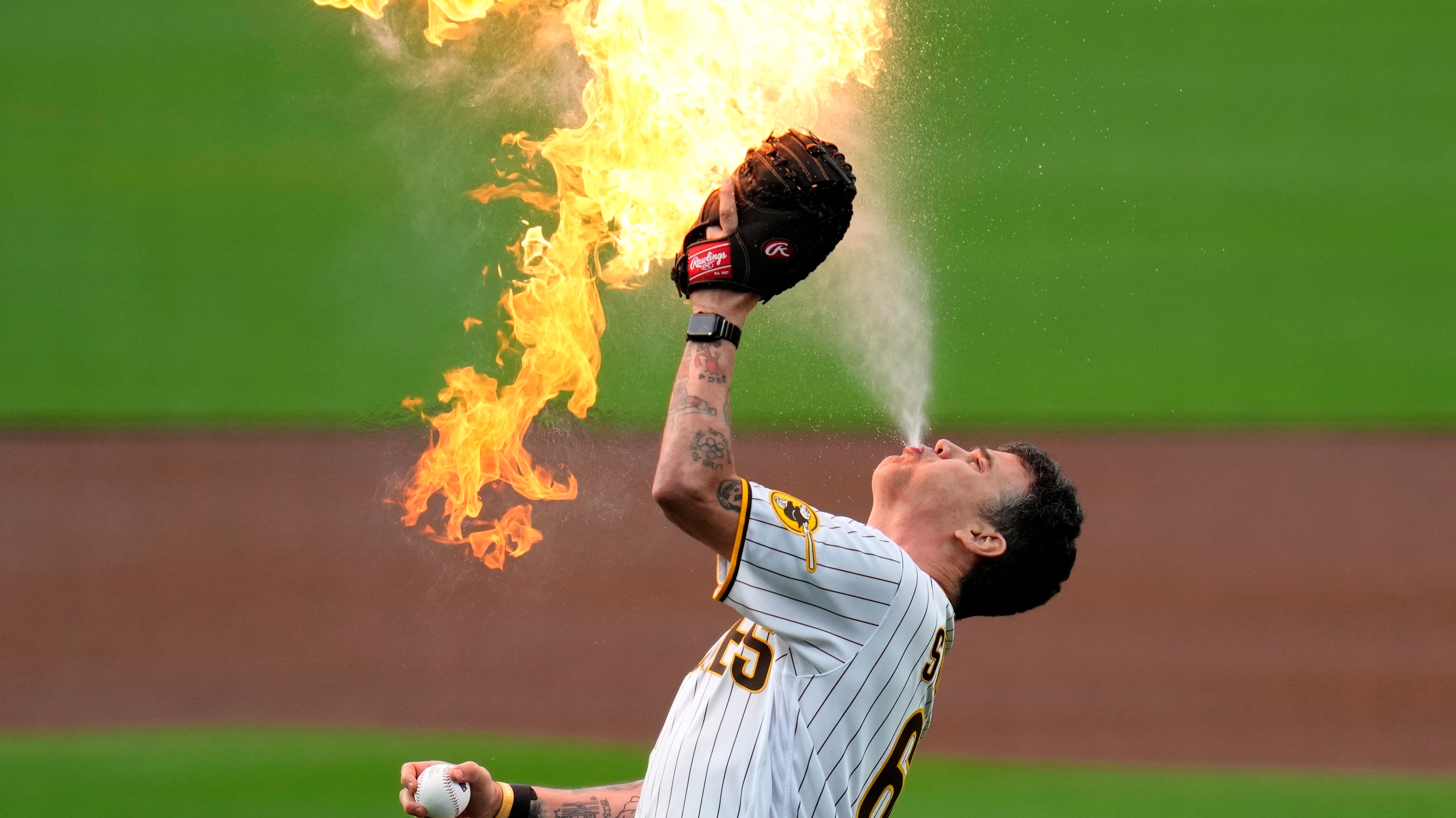 Entertainer Steve-O, from the "Jackass" series, prepares to throw the ceremonial first pitch with flames before the San Diego Padres host the Kansas City Royals in a 2023 baseball game in San Diego. (AP Photo/Gregory Bull)