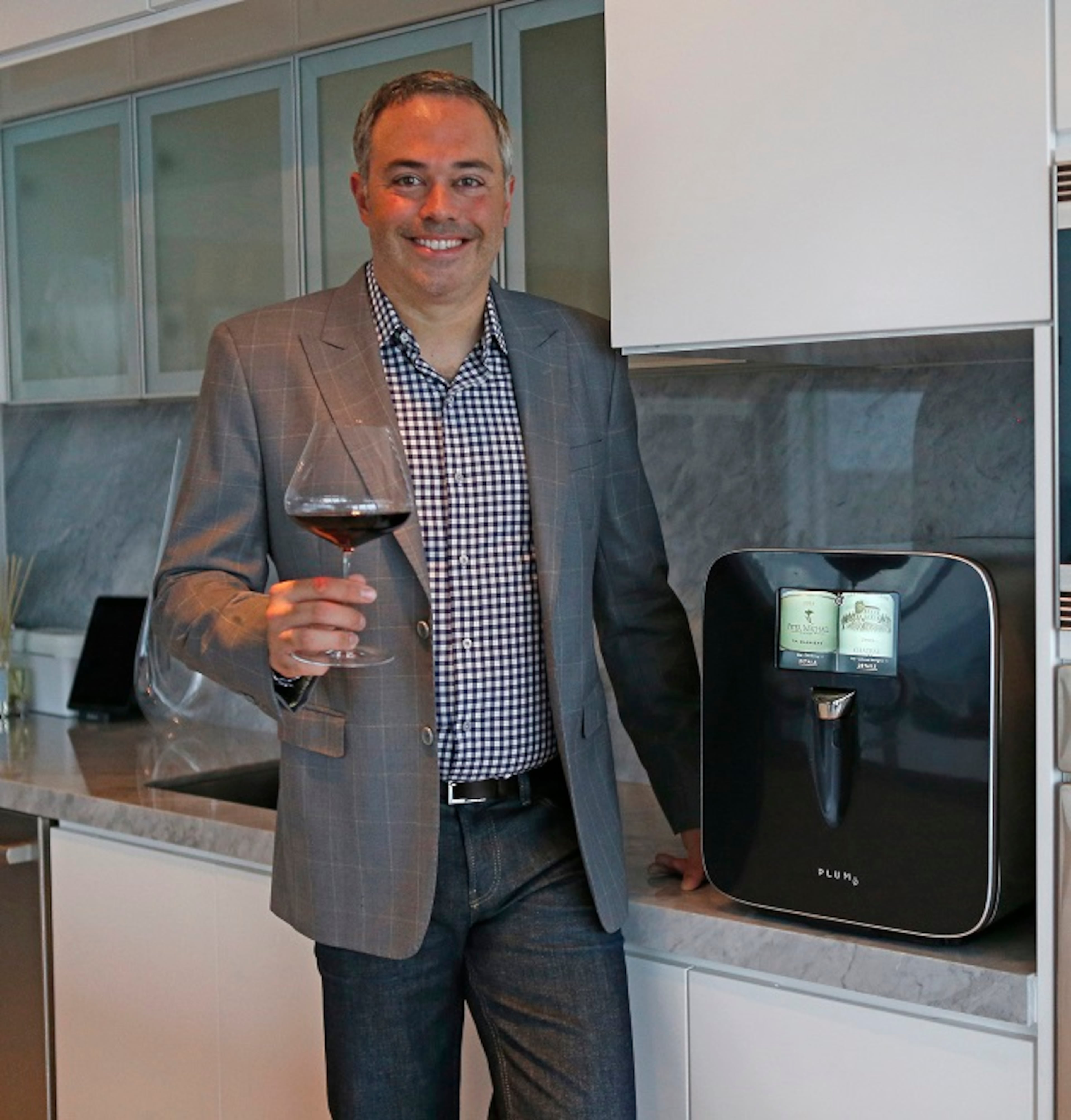 David Koretz, CEO of Plum, poses for the pictures at his home on Wednesday, Sept. 6, 2017 in Miami, Fla. David Koretz' company Plum has created a high-tech wine appliance that serves wine at the perfect temperature and can save it for months, still serving wine as it was intended. (David Santiago/Miami Herald/TNS)