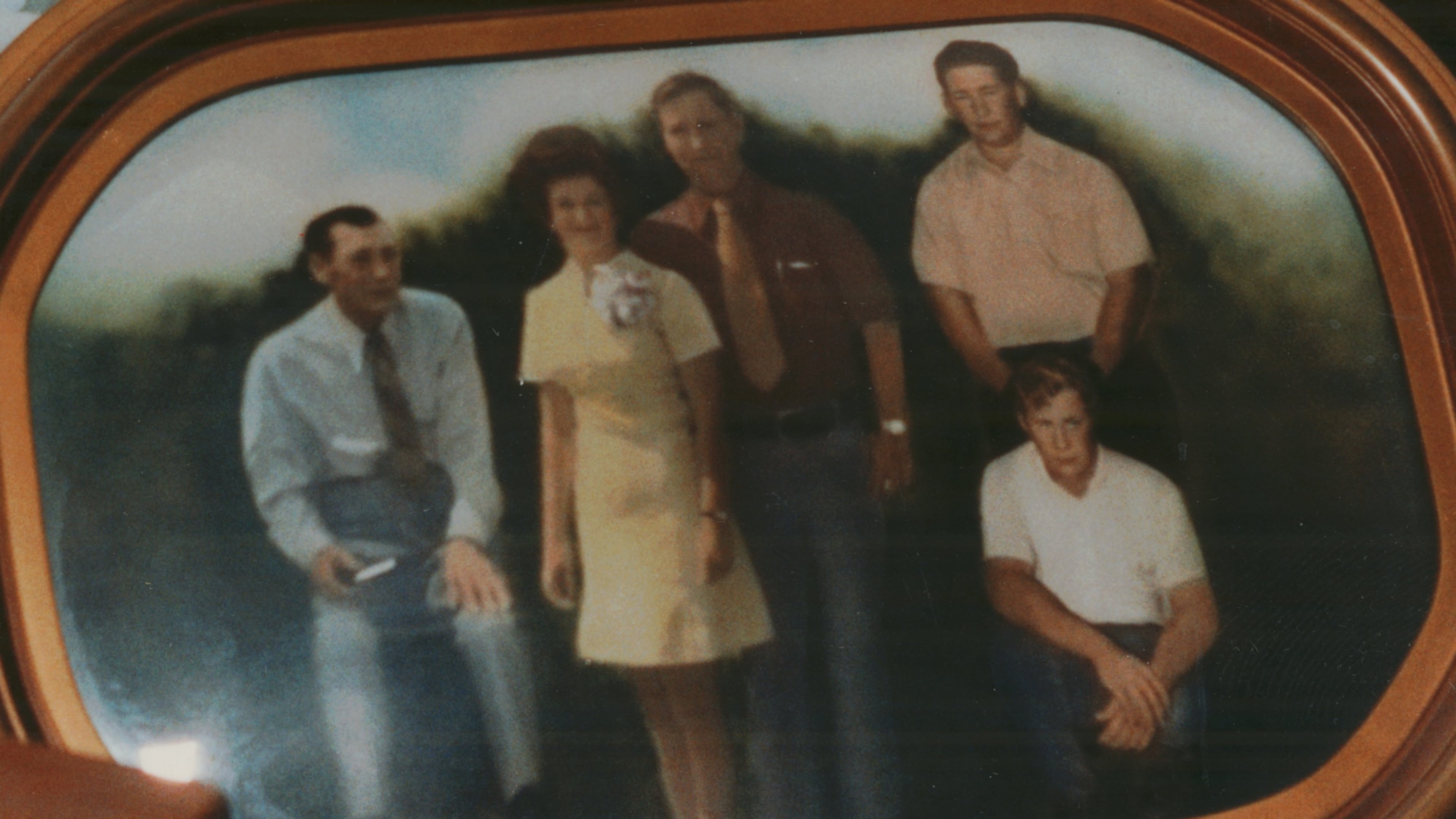 May 12, 1993 - SEMINOLE COUNTY, GA -- Ned Alday's widow, Ernestine, holds a photograph of slain members of her Seminole farm family: her husband, brother-in-law, three sons and daughter-in-law. (Stringer/AP)