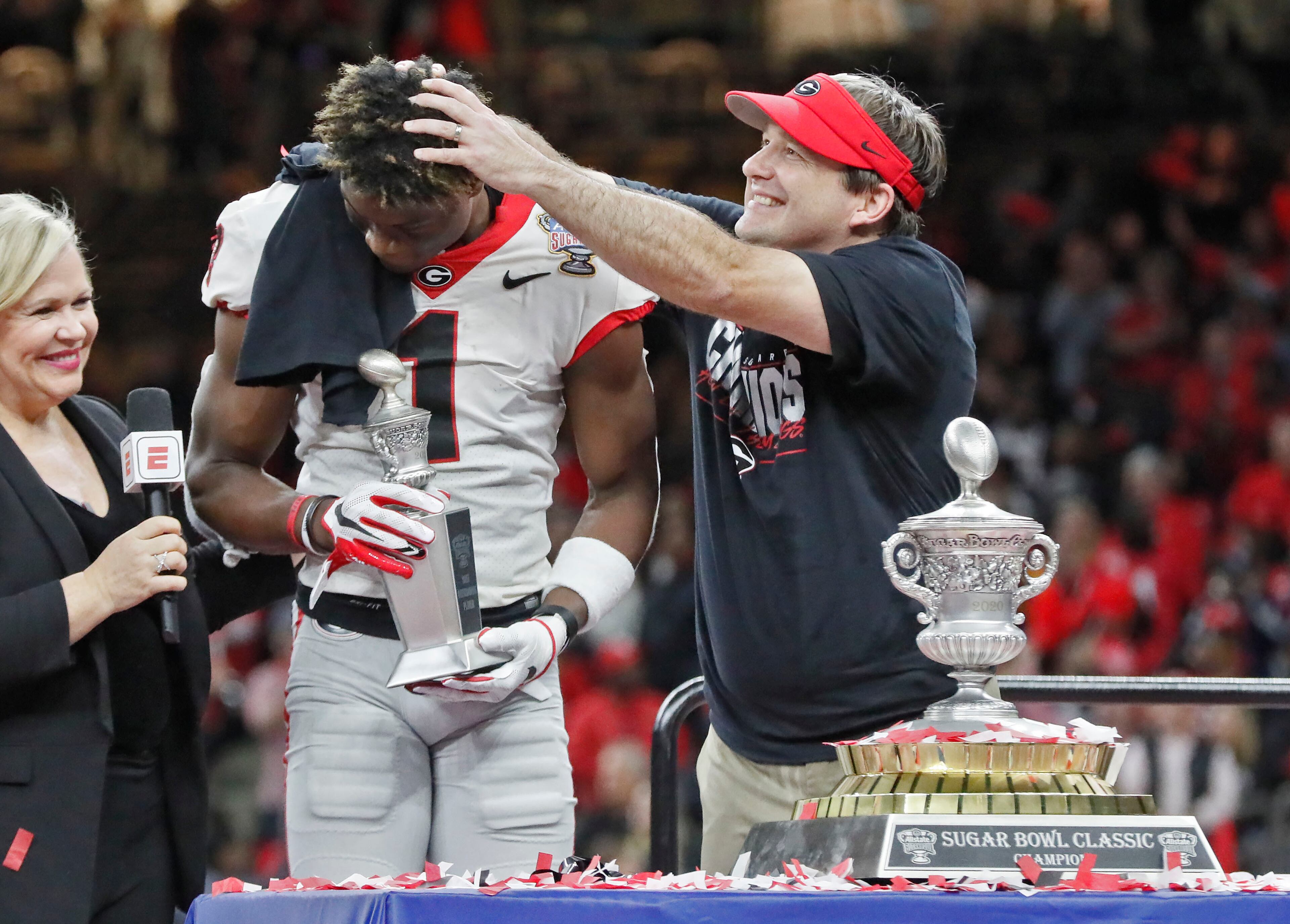 Georgia Bulldogs head coach Kirby Smart gives MVP George Pickens a head rub during the trophy presentation. Bob Andres bandres@ajc.com
