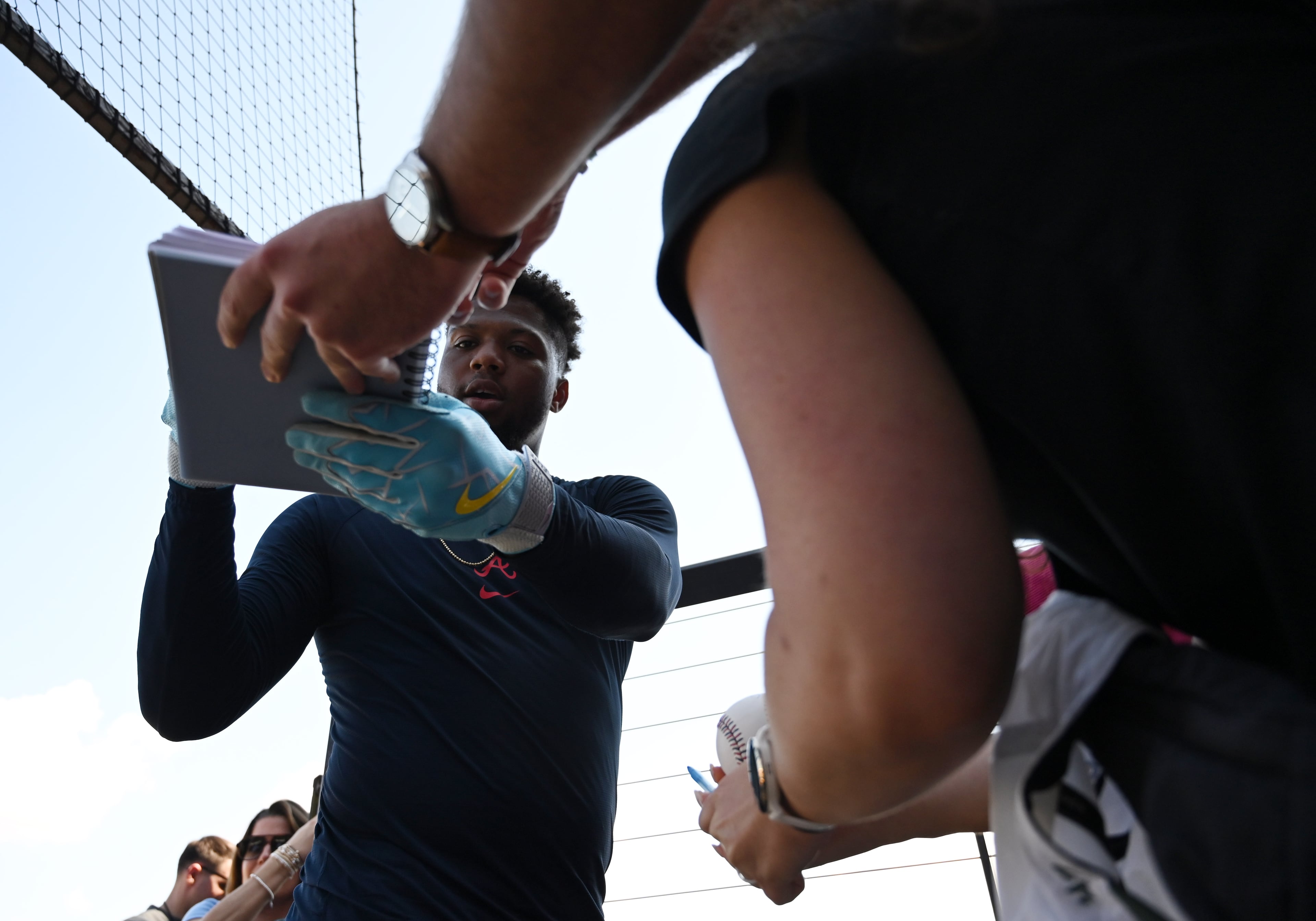 Atlanta Braves right fielder Ronald Acuña Jr. signs an autograph for fans during spring training workouts at CoolToday Park, Saturday, Feb. 14, 2026, in North Port, Fla. (Hyosub Shin/AJC)