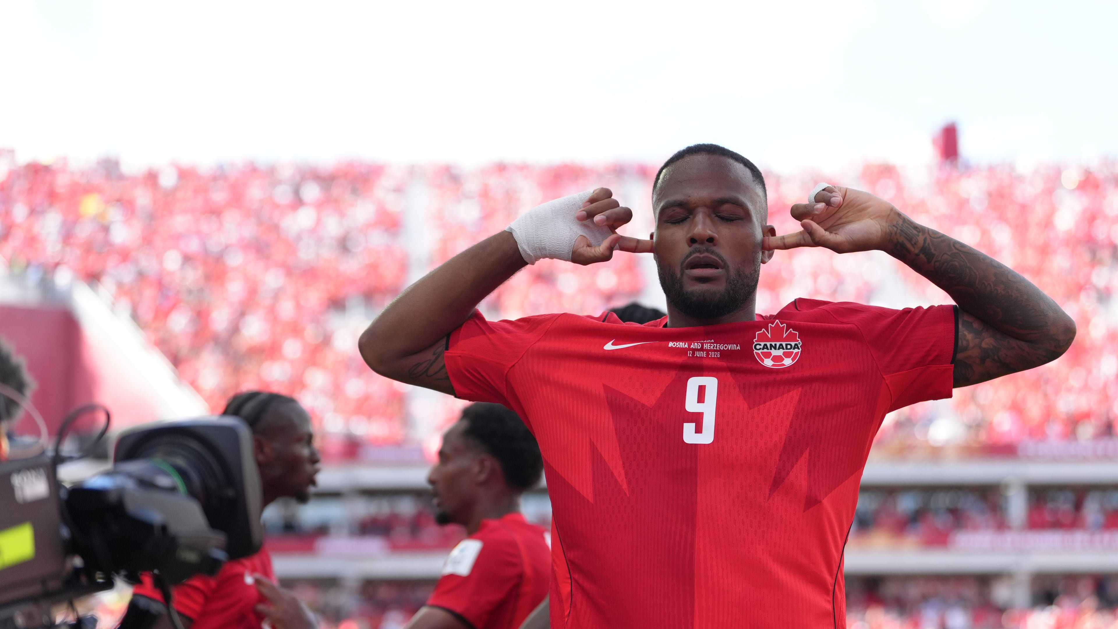 Canada's Cyle Larin (9) celebrates after scoring his sides first goal of the game in the second half of the World Cup Group B soccer match between Canada and Bosnia, Friday, June 12, 2026, in Toronto. ( (AP Photo/Sam Balkansky)
