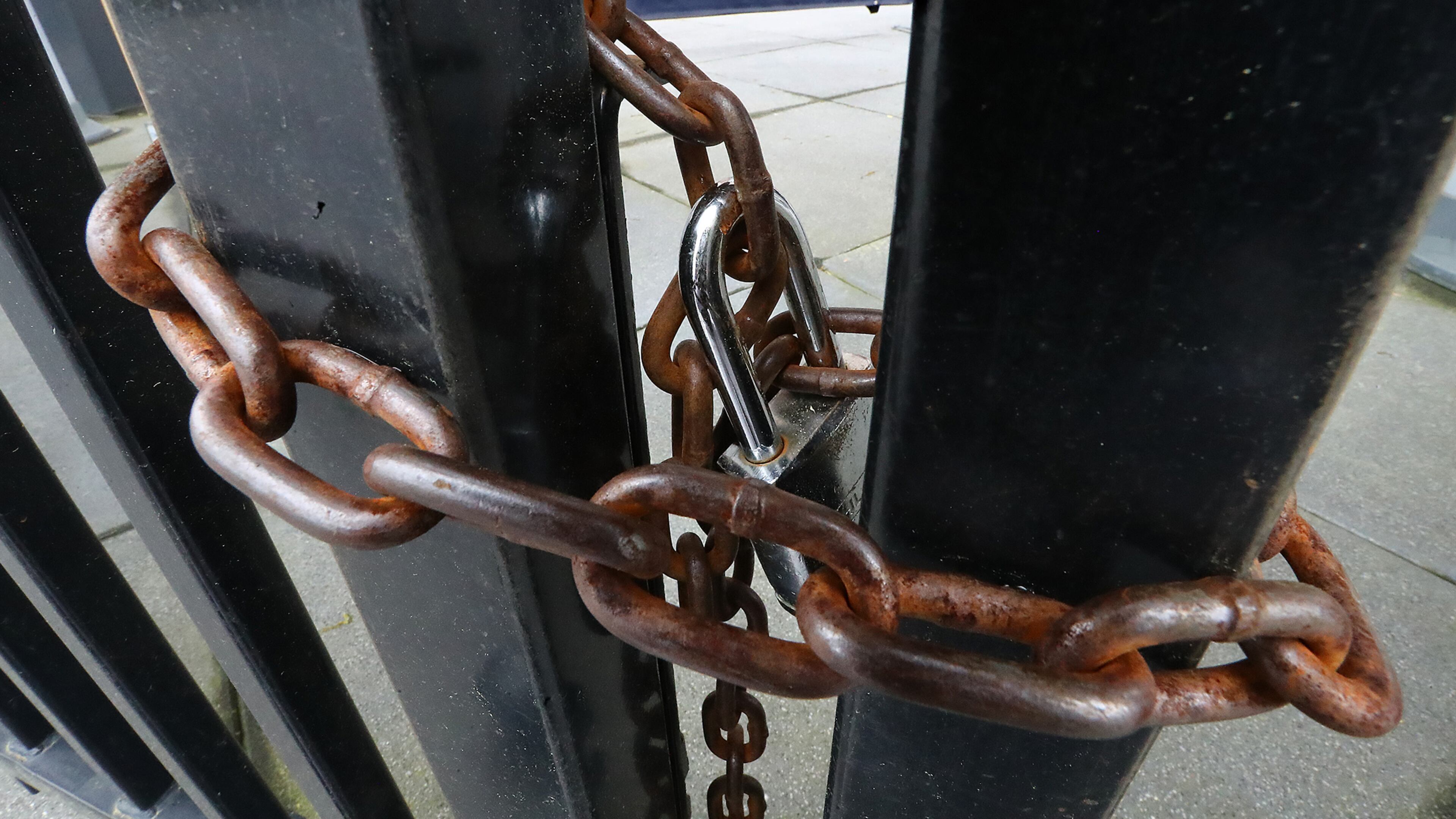 With the MLB season postponed indefinitely, the third-base gate at Truist Park is chained shut.
