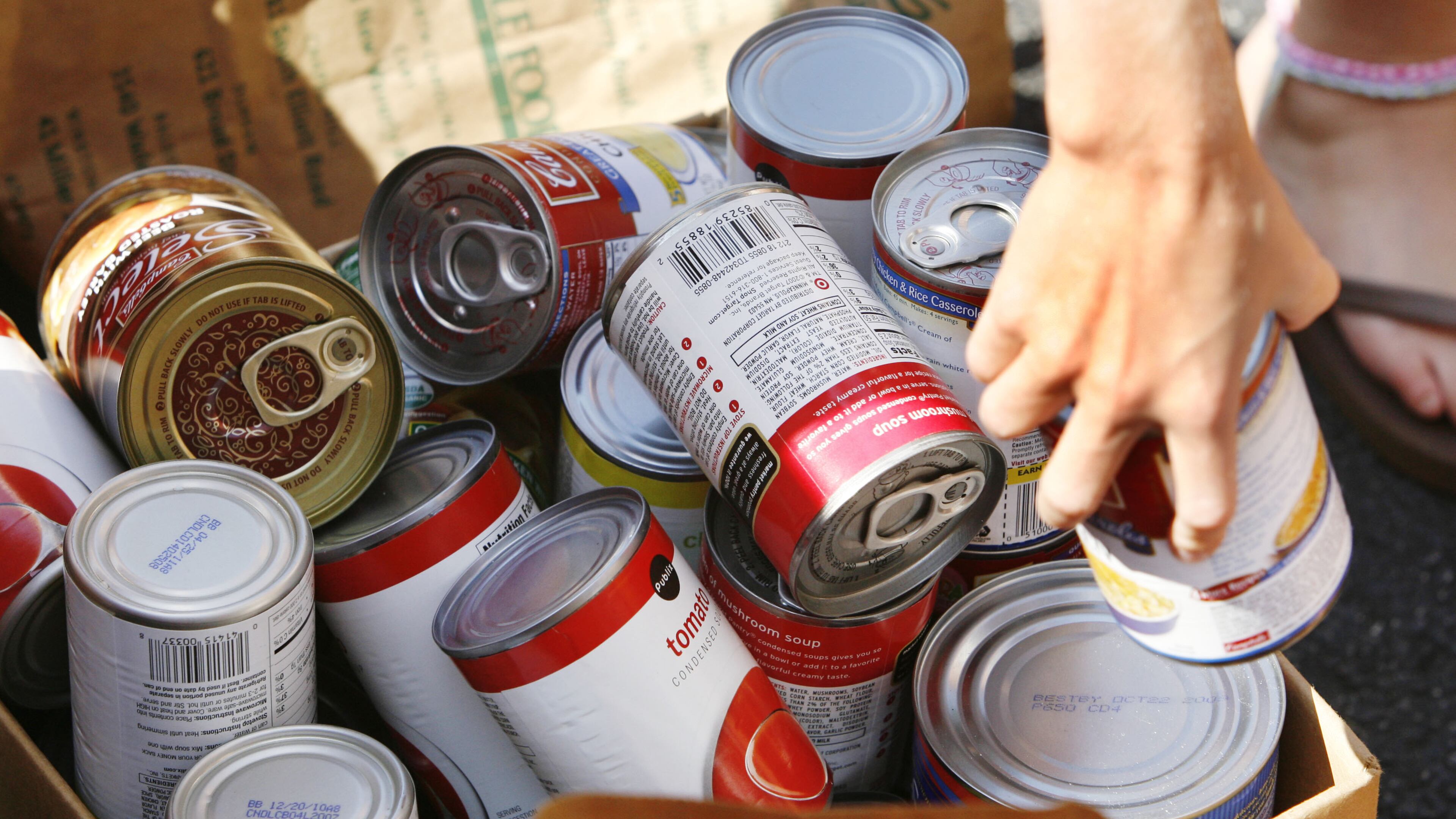 A volunteer sorts some of the cans of food donated to North Fulton Community Charities. Photo credit: Bob Andres