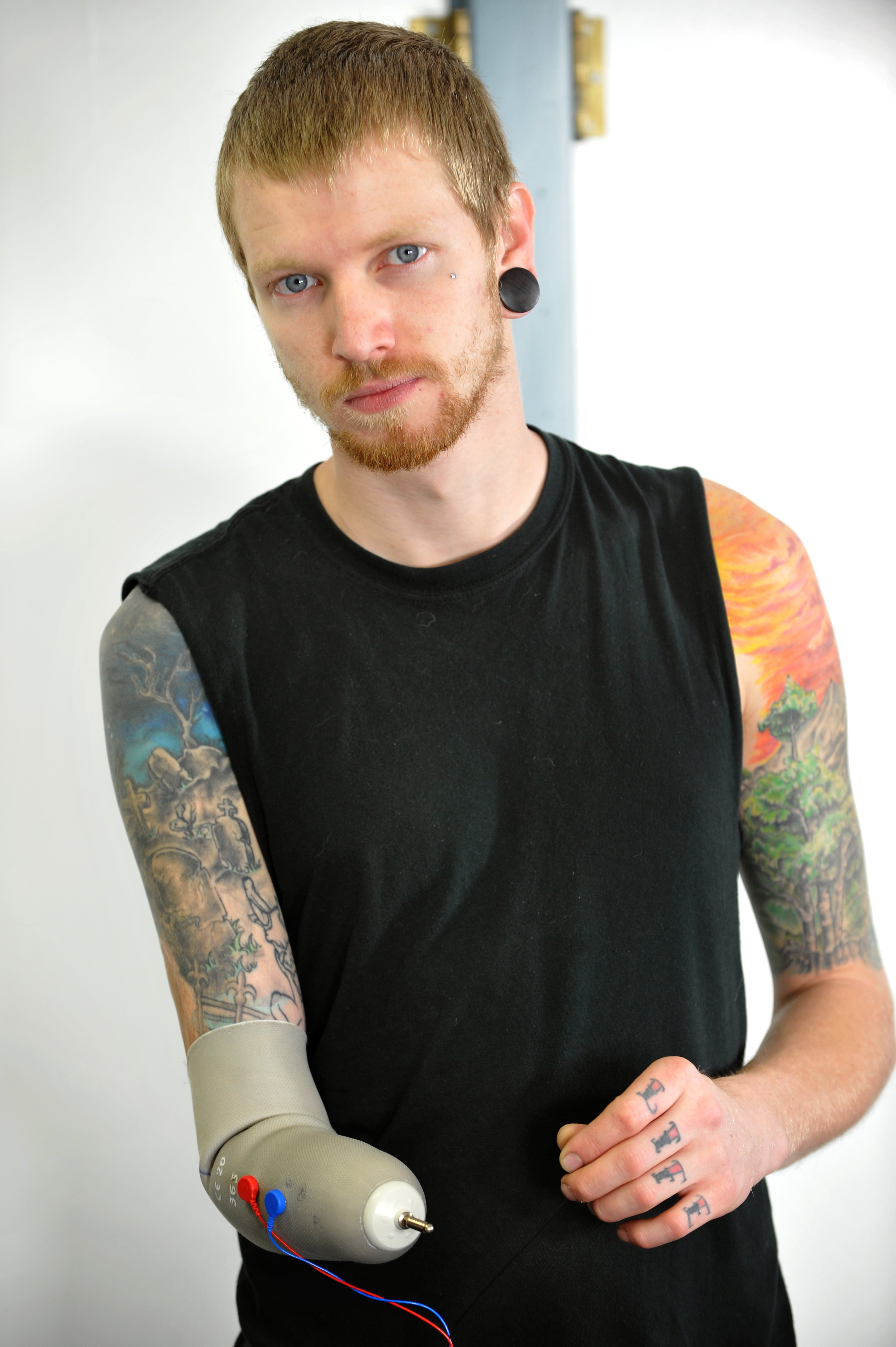 Rock, blues and jazz drummer Jason Barnes lost his right hand in an accident but a team of Georgia Tech robotics specialists devised a myo-electrically controlled robot arm to replace his missing drumming hand and they fine-tune the new wearable drumming device in their music lab Sunday, March 16, 2014, in Atlanta. David Tulis / AJC Special