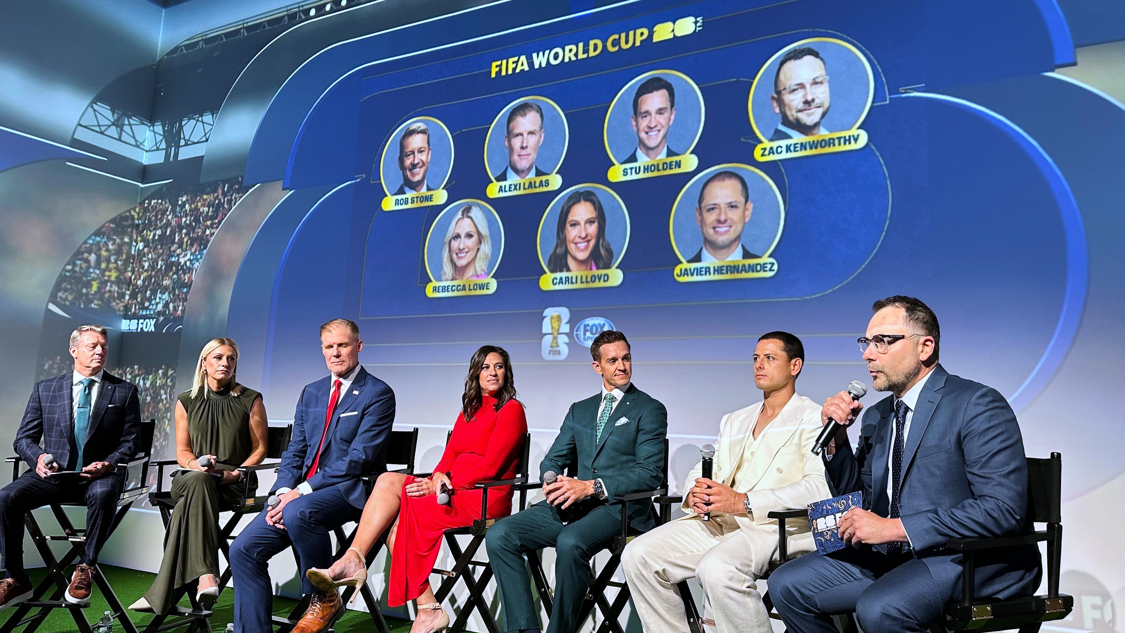 Fox Sports hosts, from left, Rob Stone and Rebecca Lowe, and former player/analysts Alexi Lalas, Stu Holden and Javier Hernandez listen as Fox Sports' vice president of production Zac Kenworthy speaks during a World Cup soccer new conference, Thursday, May 21, 2026, in New York. (AP Photo/Ronald Blum)