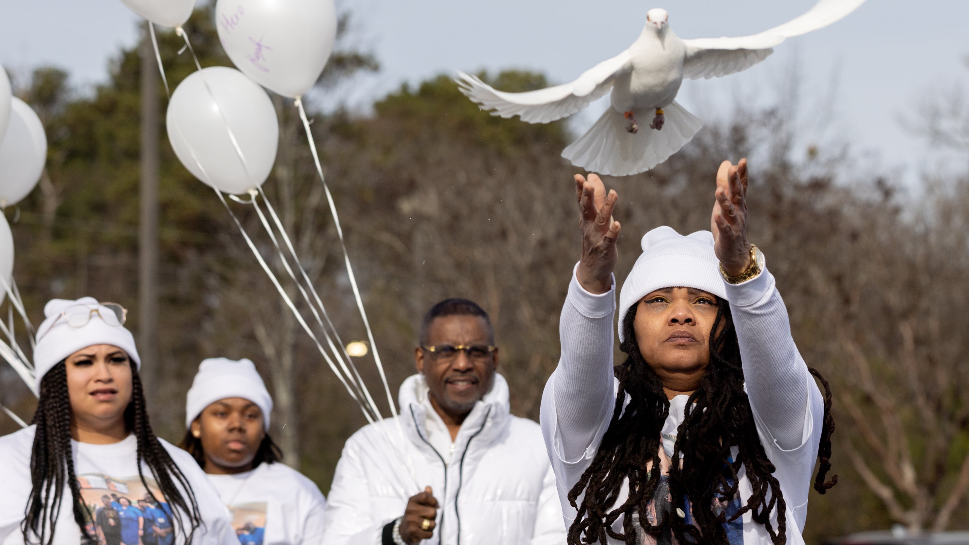 Friends, relatives and colleagues of Stacy Redmond, including co-worker Myshirdie Welch, gathered Wednesday for a vigil at the Kroger where he worked in Tucker.