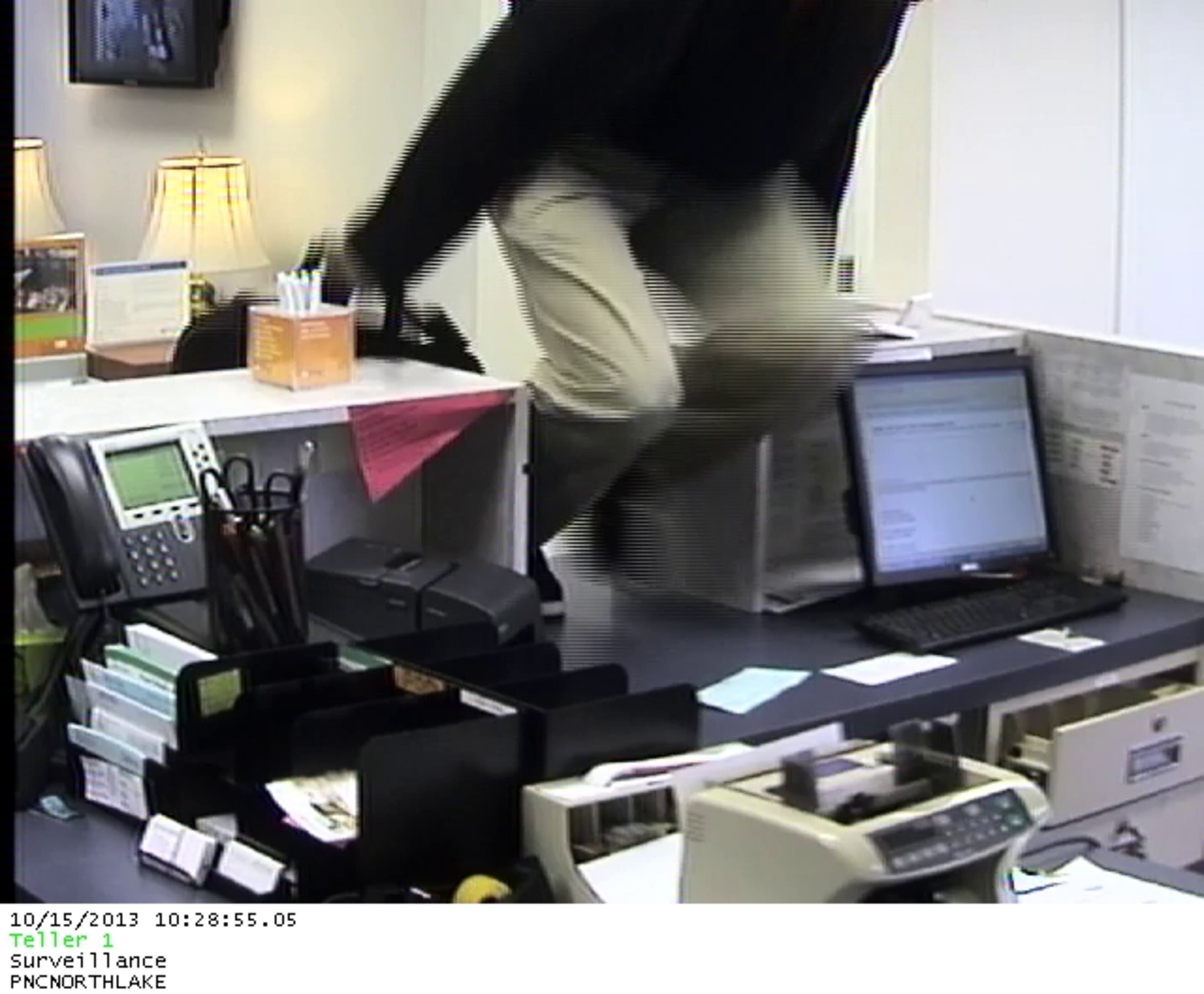 The robber is described as a black male in his late 30s to early 40s with stocky build, weighing about 200 pounds. He appears to be 5'10" to 5'11."