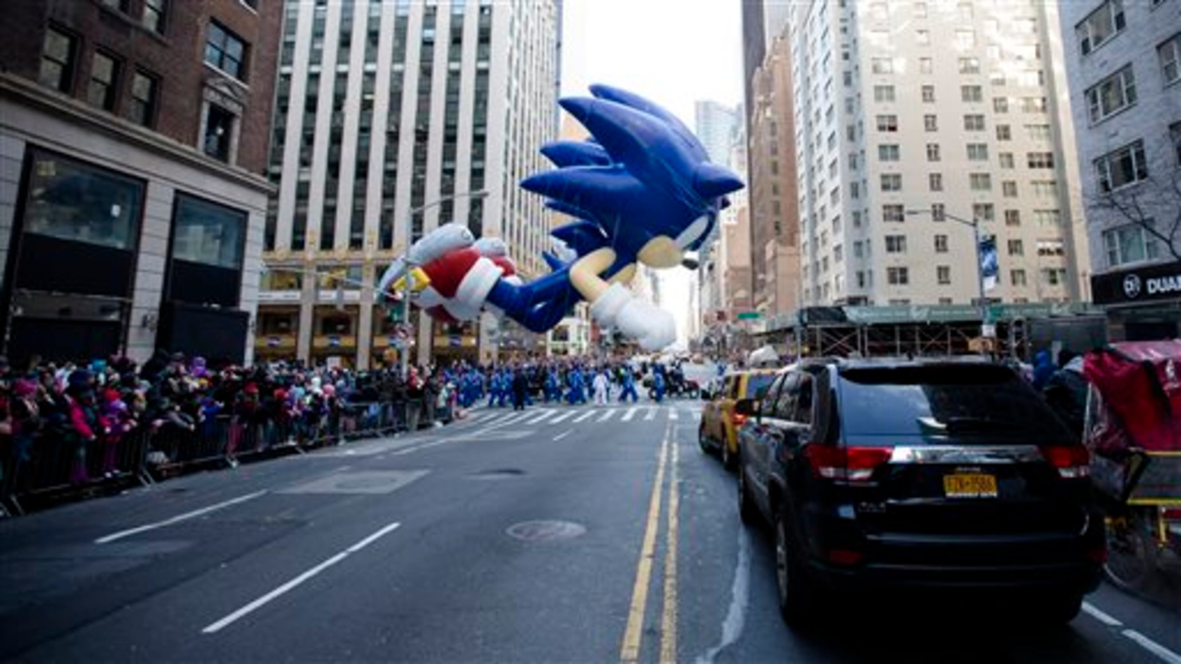 A giant Sonic the Hedgehog balloon is marched down 6th Avenue during the 87th Annual Macy's Thanksgiving Day Parade, Thursday, Nov. 28, 2013, in New York. After fears the balloons could be grounded if sustained winds exceeded 23 mph, Snoopy, Spider-Man and the rest of the iconic balloons received the all-clear from the New York Police Department to fly between Manhattan skyscrapers on Thursday. (AP Photo/John Minchillo)