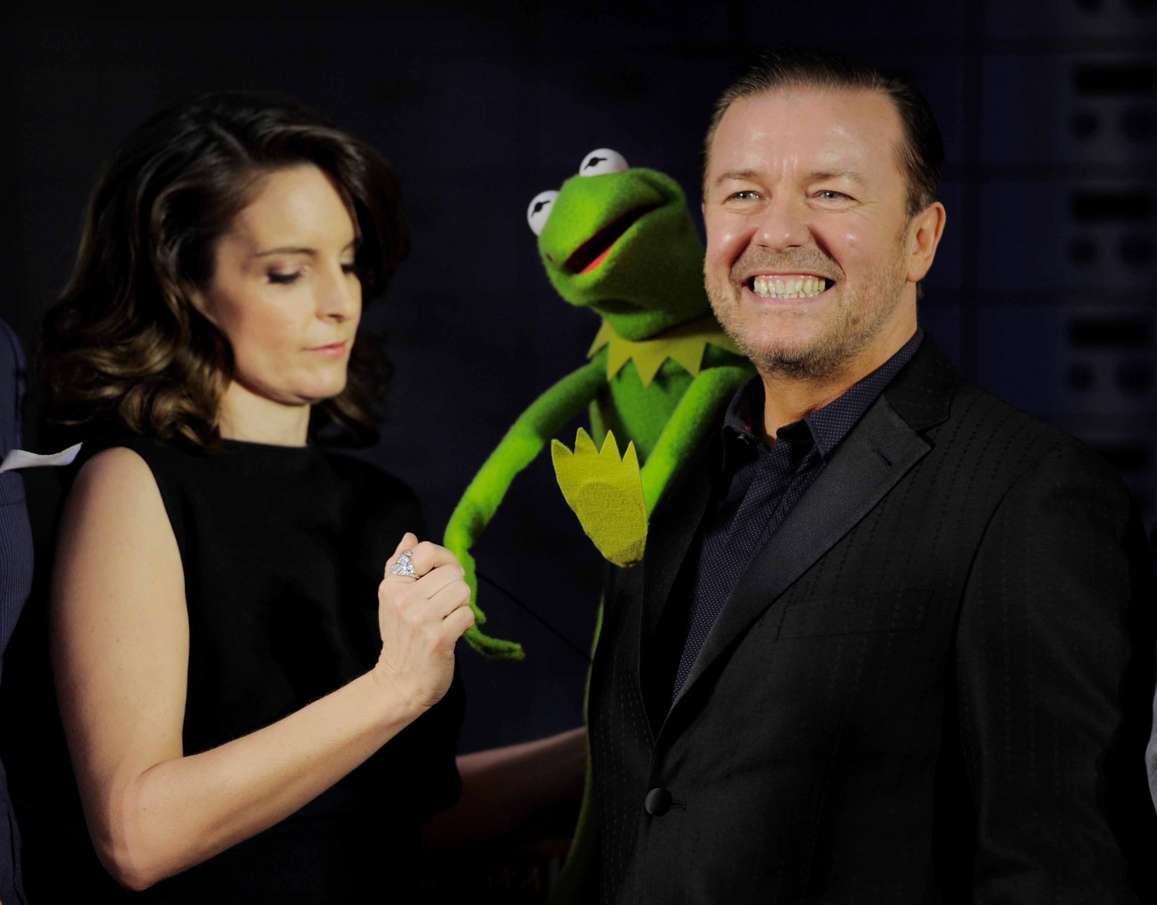 "Muppets Most Wanted" characters Ricky Gervais, right, and Tina Fey pose with Kermit the Fog at the premiere of the film on Tuesday, March 11, 2014, in Los Angeles. (Photo by Chris Pizzello/Invision/AP)