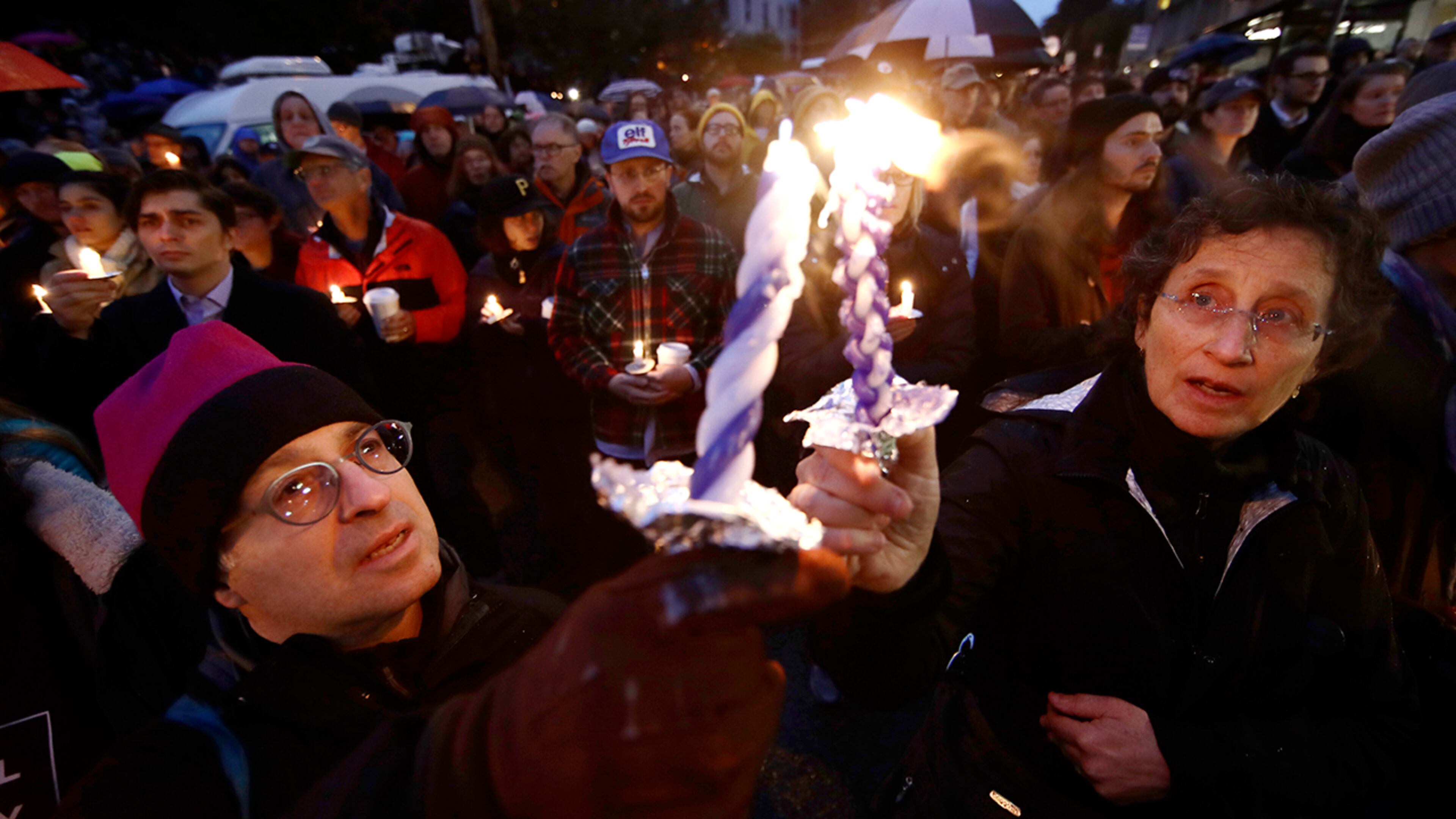 People light candles as they gather for a vigil in the aftermath of a deadly shooting at the Tree of Life Congregation, in the Squirrel Hill neighborhood of Pittsburgh, Saturday, Oct. 27, 2018. (AP Photo/Matt Rourke)