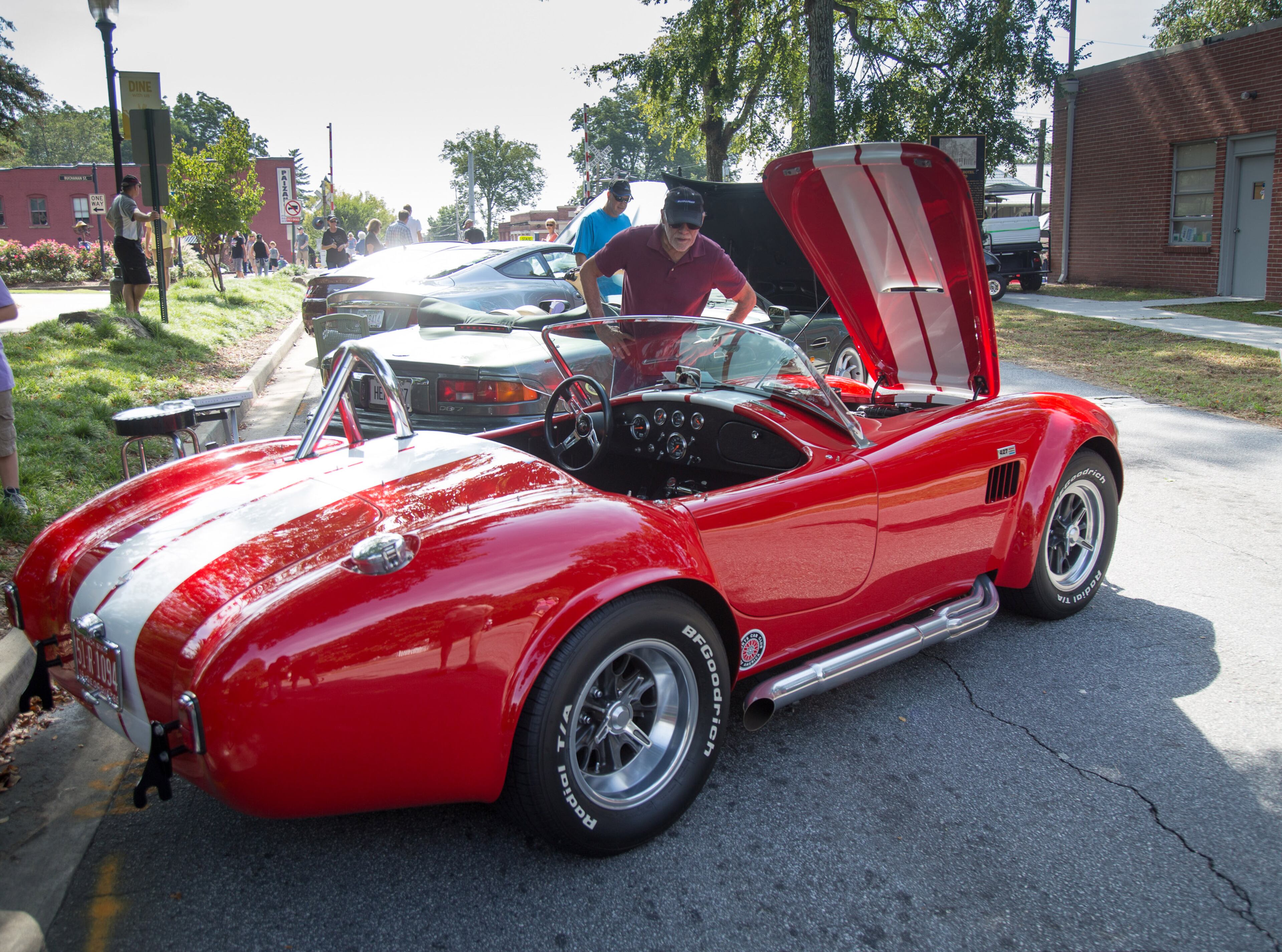 Gill Wesley checks out a 1966 Ford Cobra Replica during the 8th annual Atlanta British Car Fayre in downtown Norcross on Saturday, Sept. 8, 2018. (Photo: STEVE SCHAEFER / SPECIAL TO THE AJC)