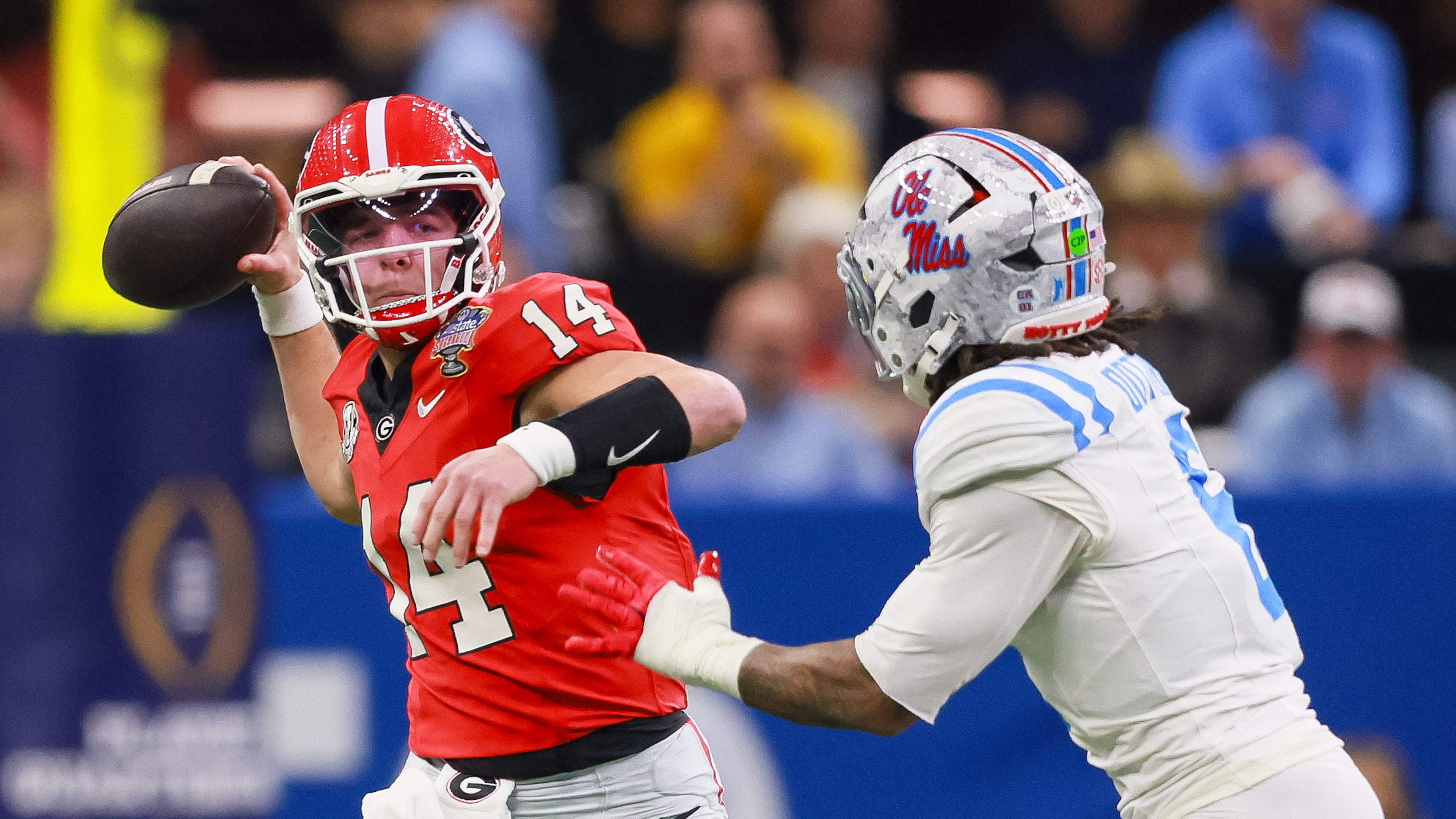 Georgia quarterback Gunner Stockton throws under pressure from Ole Miss linebacker TJ Dottery during the College Football Playoff quarterfinal game Jan. 1, 2026. (Jason Getz/AJC)