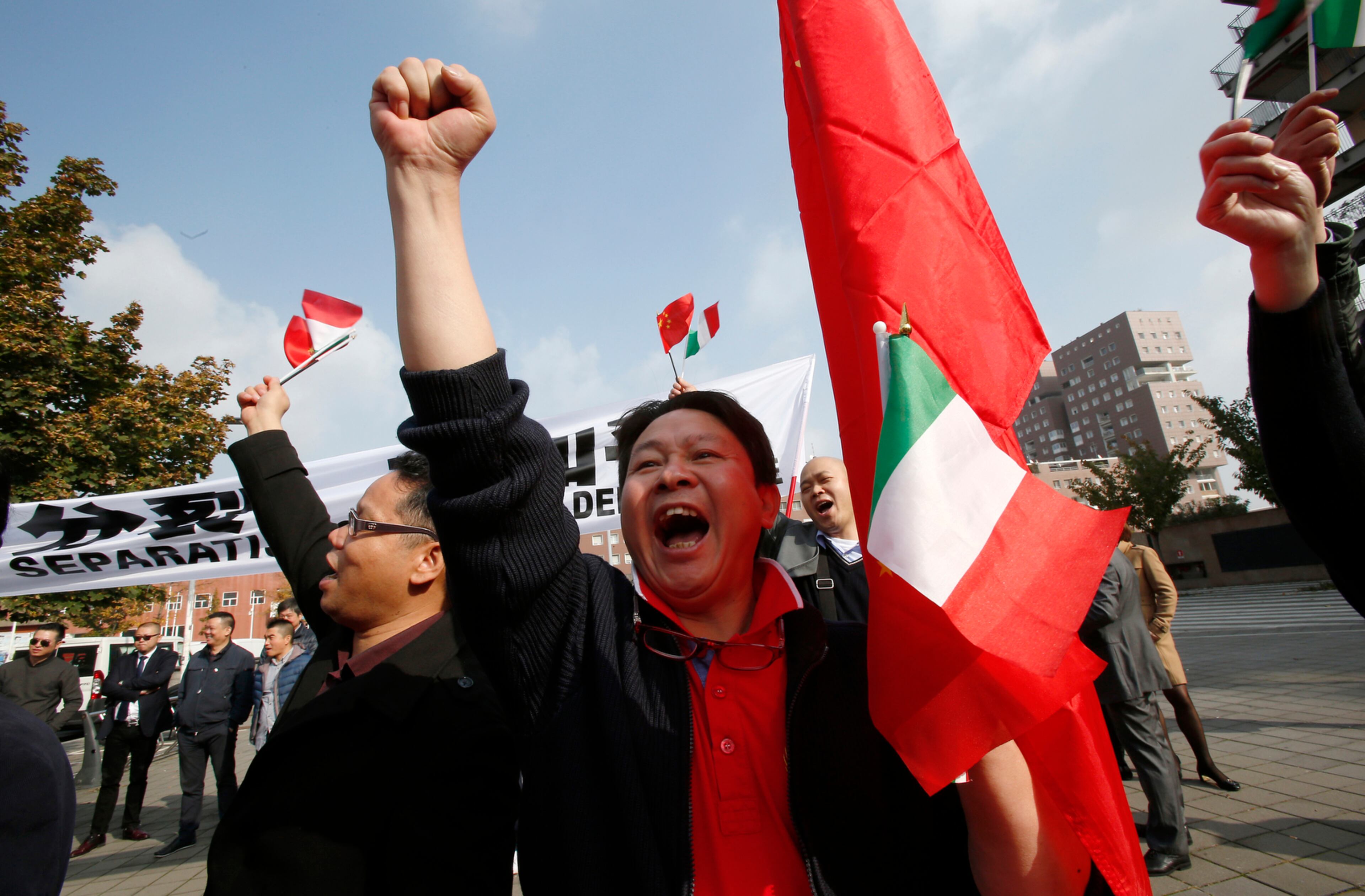 Chinese protesters demonstrate outside the University of Milan-Bicocca where the Dalai Lama will be made honorary citizen, in Milan, Italy, Thursday, Oct. 20, 2016. The Chinese Embassy in Rome has strongly protested plans by Milan city council to bestow honorary citizenship Thursday on the Dalai Lama, saying it would have a negative impact on bilateral relations and regional cooperation. (AP Photo/Antonio Calanni)