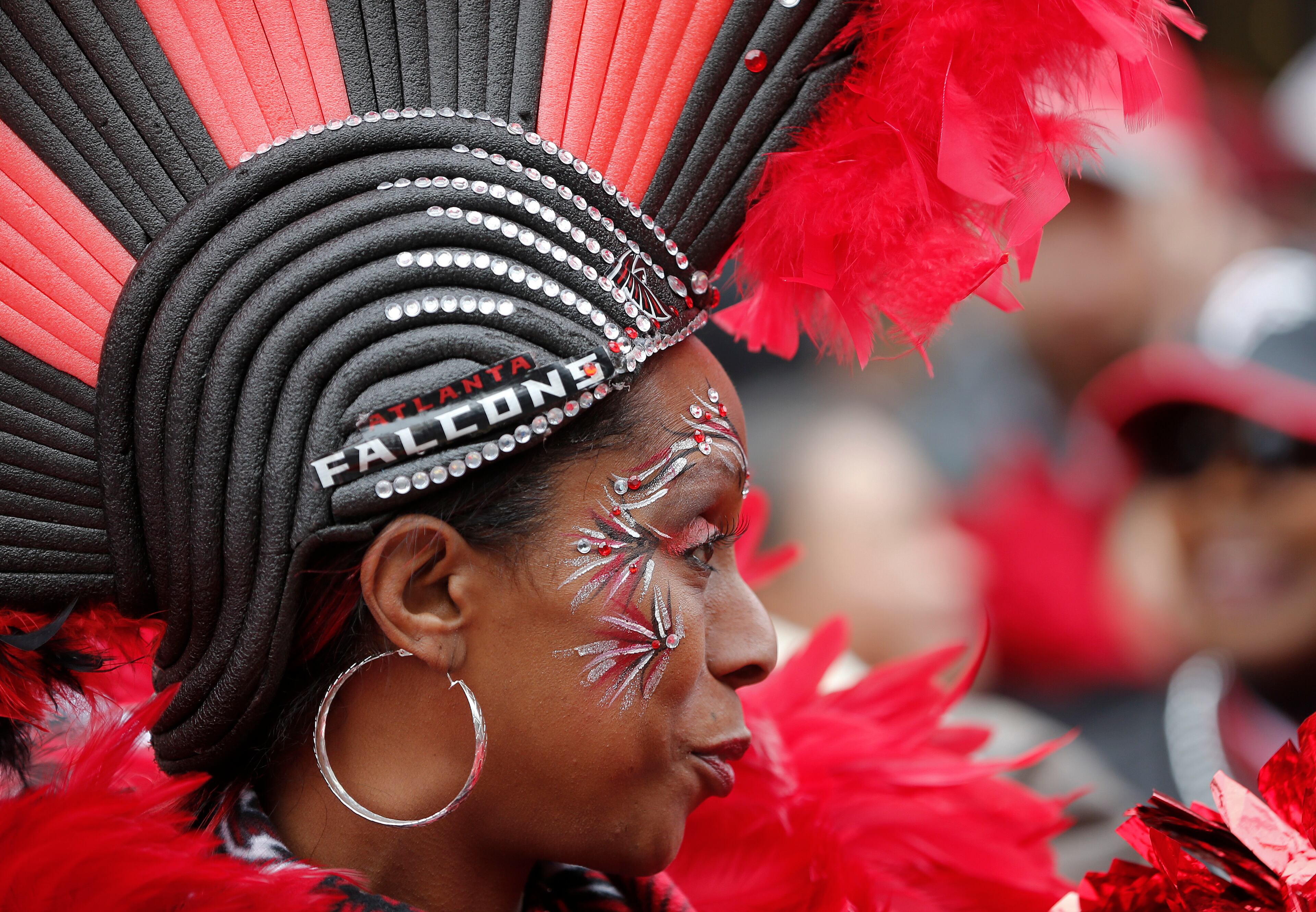 Keisha Burns, who said she is the original "Bird Lady," waits for the buses carrying the Atlanta Falcons NFL football team to pass by during a send-off pep rally for the team as they make their way to the airport for a flight to Houston and Super Bowl LI, Sunday, Jan. 29, 2017, in Atlanta.