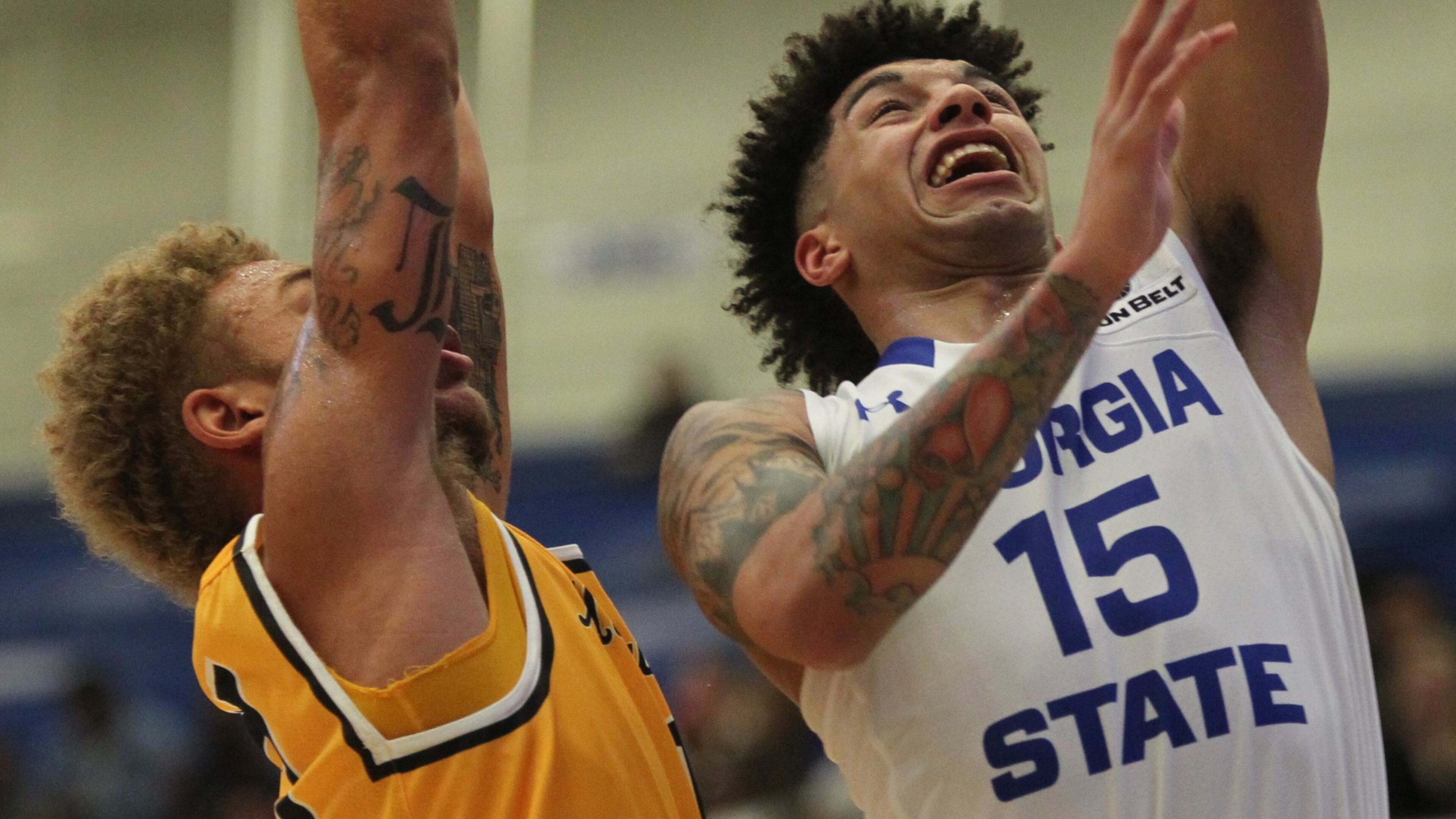 Georgia State guard D’Marcus Simonds (15) leaps away from an ASU player to score a basket in a Sun Belt Conference college basketball game between Georgia State University and Appalachian State University in Atlanta, Georgia, on Monday, January 23, 2017. (HENRY TAYLOR / HENRY.TAYLOR@AJC.COM)
