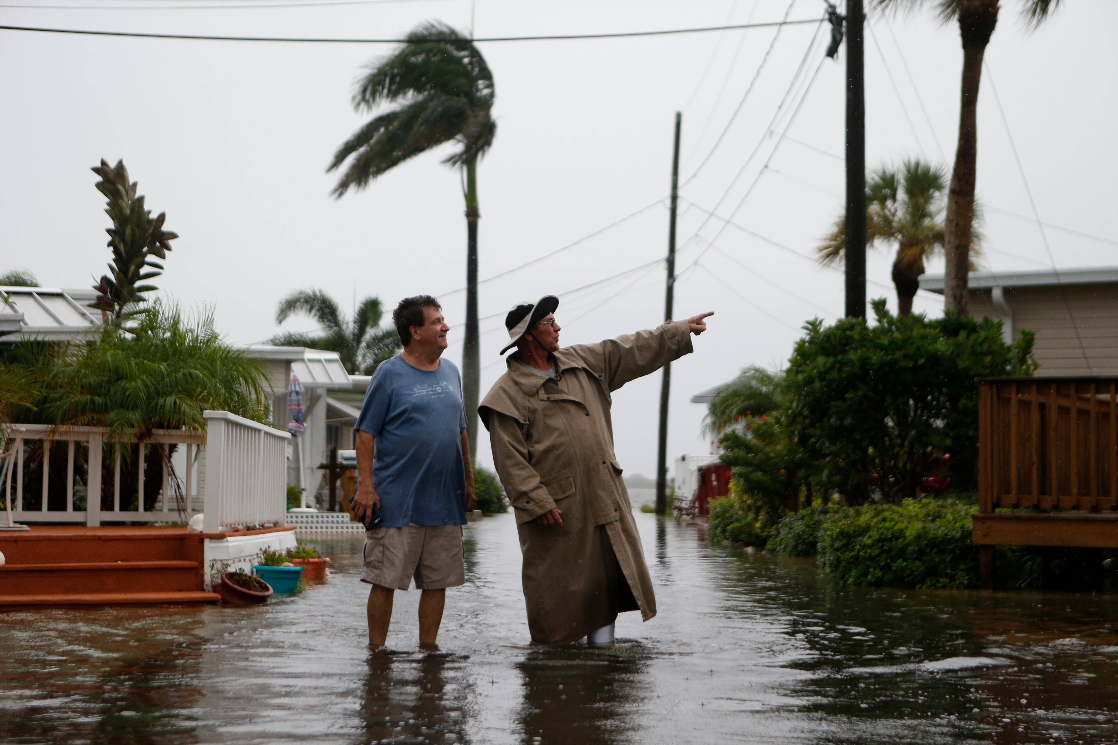 Residents of the Sandpiper Resort survey the rising water coming from the Gulf of Mexico into their neighborhood as winds and storm surge associated with Tropical Storm Hermine impact the area on September 1, 2016 in Holmes Beach, Florida. (Photo by Brian Blanco/Getty Images)