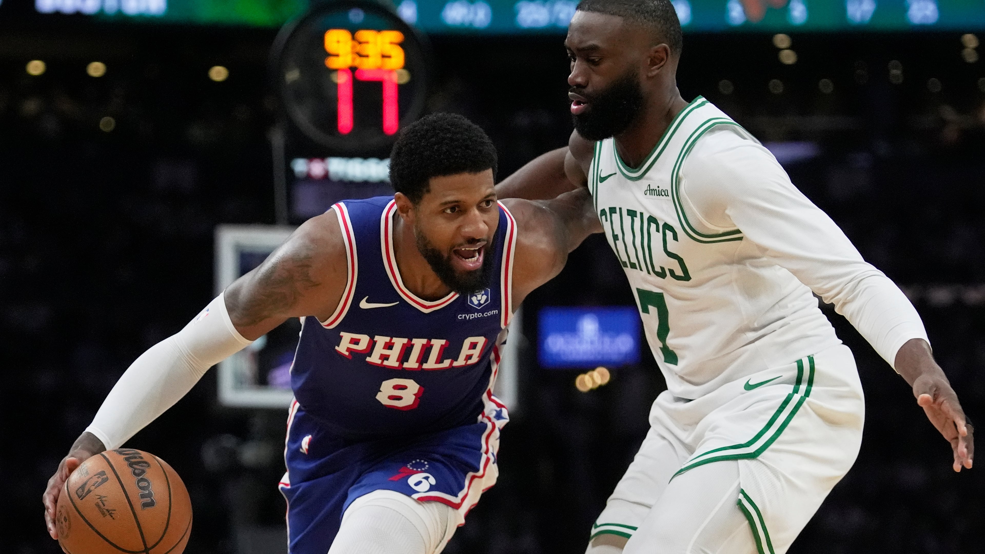 FILE - Philadelphia 76ers forward Paul George (8) drives around Boston Celtics guard Jaylen Brown (7) during the second half in Game 1 of a first-round NBA playoffs basketball game, Sunday, April 19, 2026, in Boston. (AP Photo/Robert F. Bukaty)