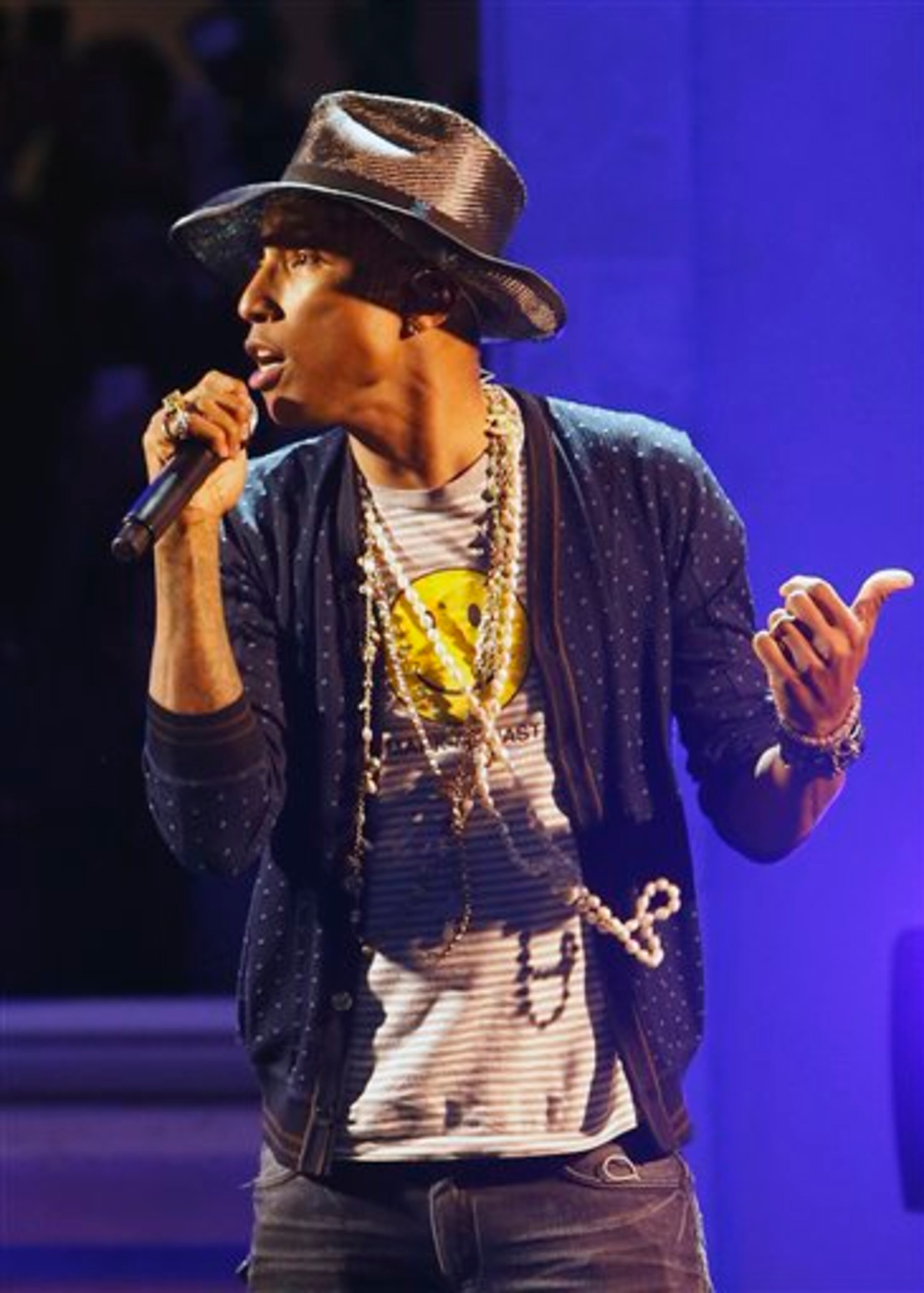 Singer Pharrell Williams performs on stage during a private concert for the exhibition "GIRL" at the Perrotin Gallery in Paris, Monday, May 26, 2014. Williams curated an exhibition encompassing around 40 art pieces, presenting their visions of femininity, muses, female creativity and freedom. The show opens on May 27 and runs through June 27. (AP Photo/Francois Mori)