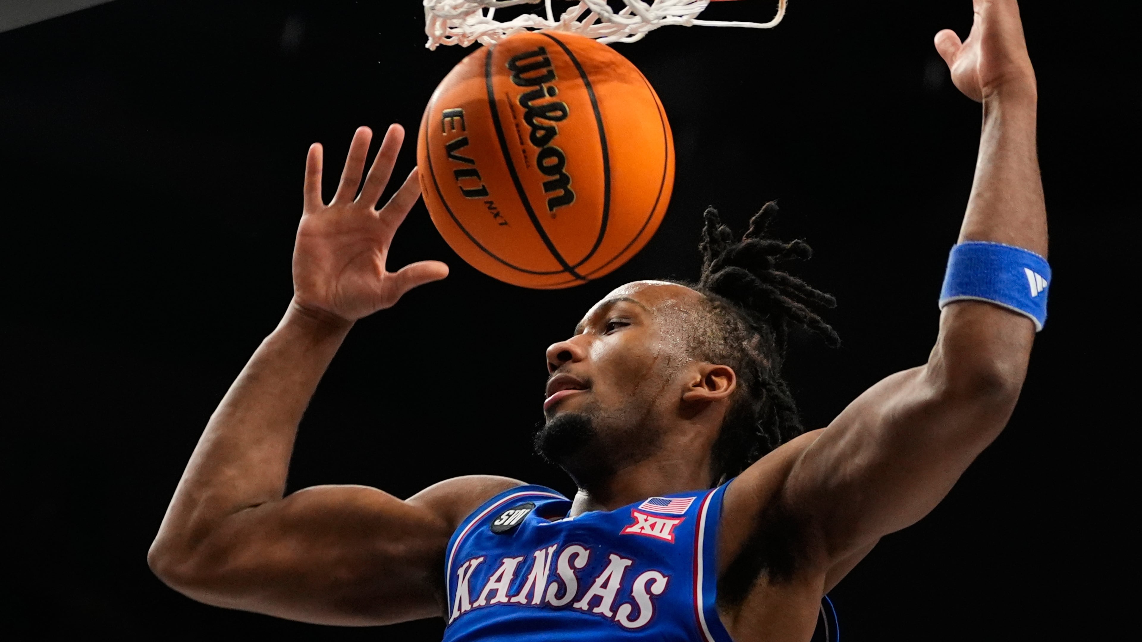 FILE - Kansas' Darryn Peterson dunks during the first half of an NCAA college basketball game against Houston in the semifinal round of the Big 12 Conference tournament March 13, 2026, in Kansas City, Mo. (AP Photo/Charlie Riedel, File)