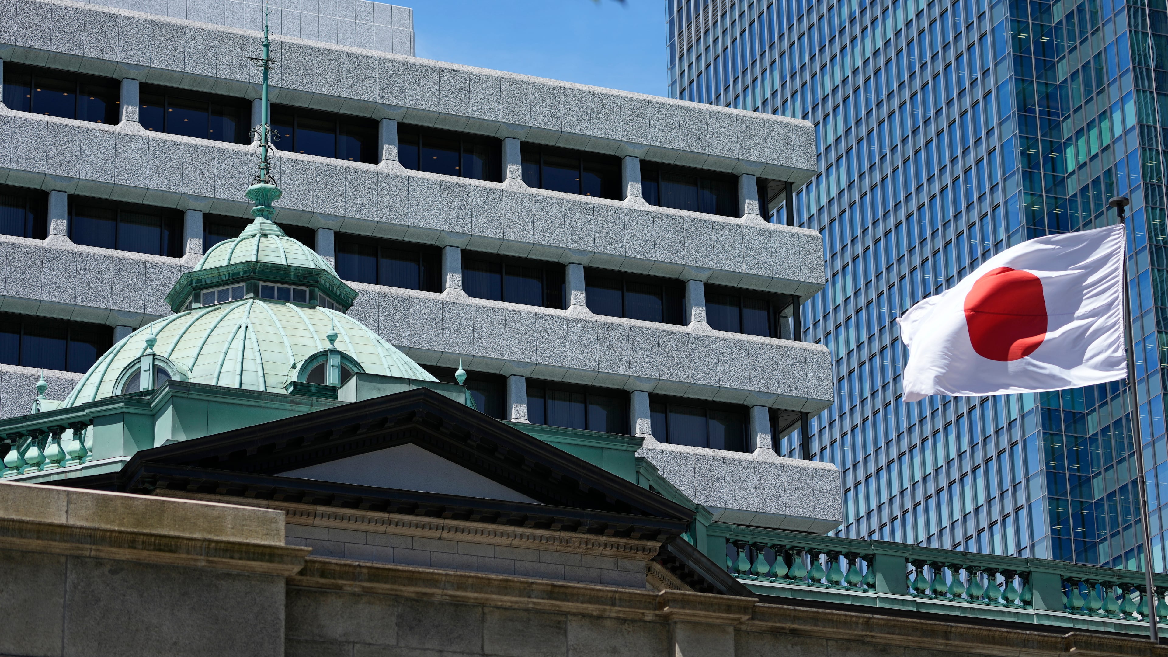 FILE - A Japanese flag flutters at the Bank of Japan headquarters in Tokyo, July 29, 2022. (AP Photo/Shuji Kajiyama, File)