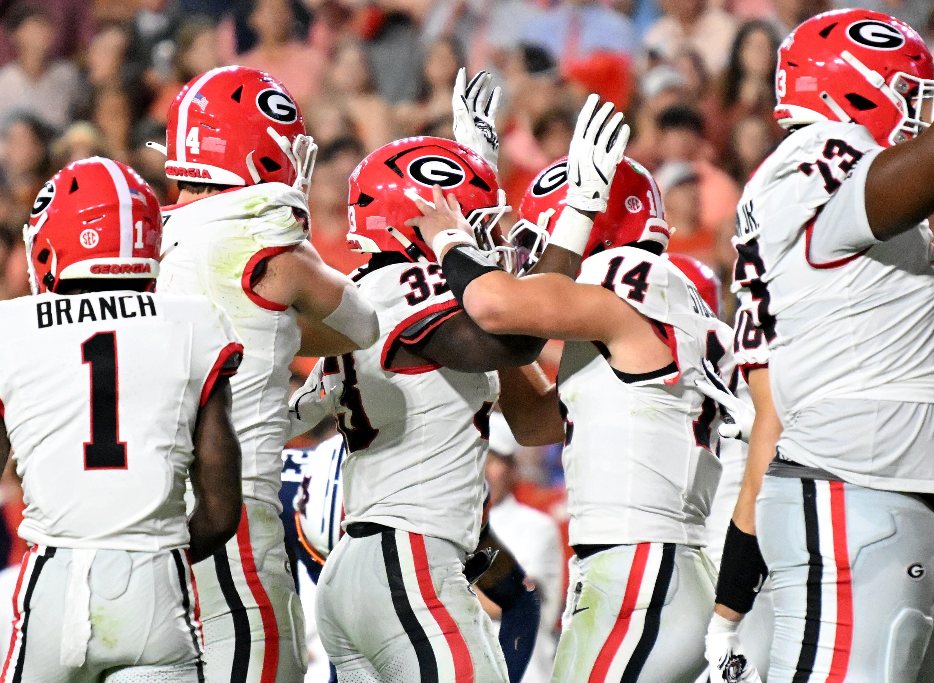 Georgia running back Chauncey Bowens (33) celebrates with Georgia quarterback Gunner Stockton (14) after scoring a touchdown during the second half in a NCAA college football game at Jordan-Hare Stadium, Saturday, October 11, 2025, in Auburn, Ala. Georgia won 20-10 overAuburn. (Hyosub Shin / AJC)