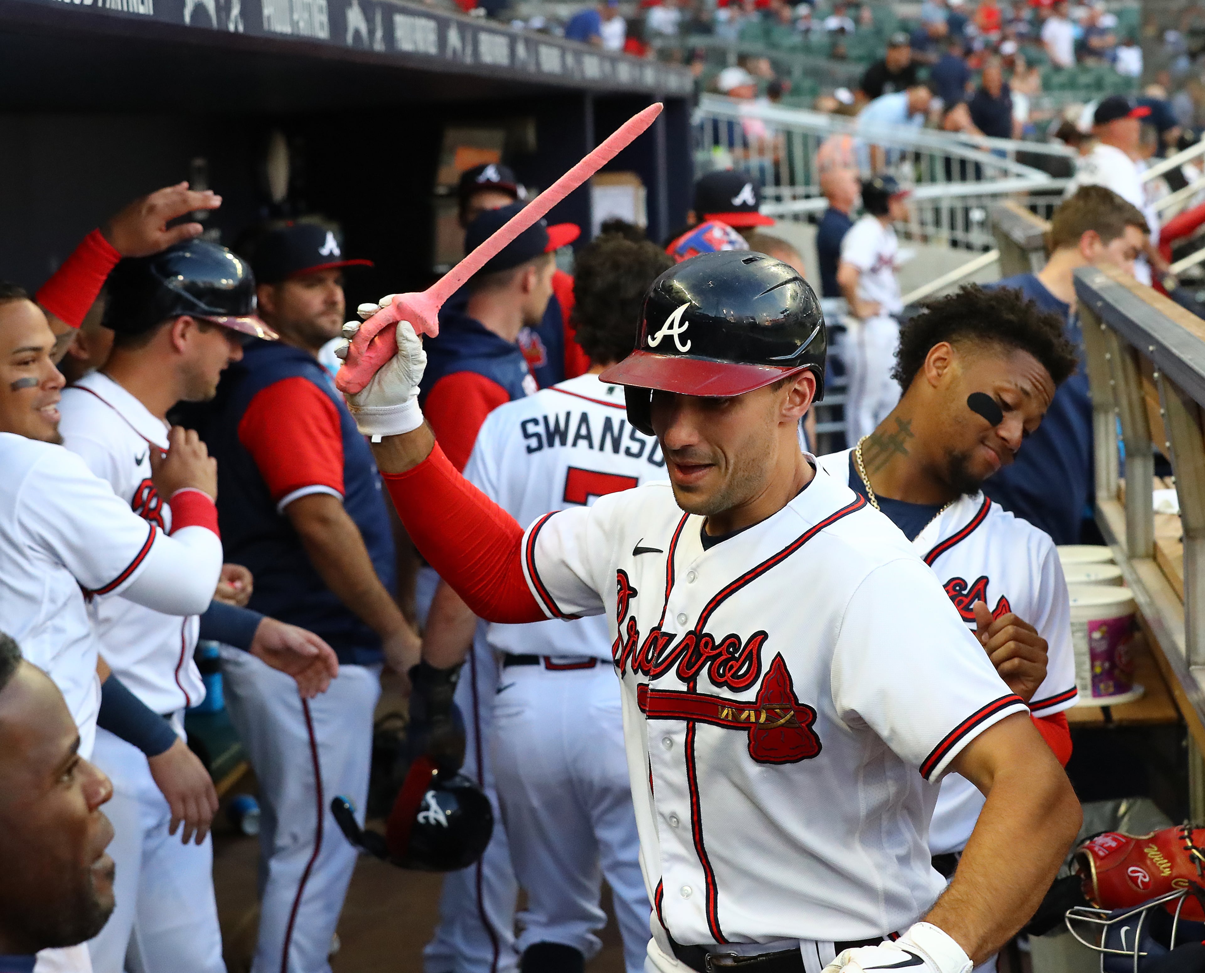 Braves first baseman Matt Olson swings the sword in the dugout with Ronald Acuna ducking after hitting a 3-run homer to take a 5-4 lead over the San Francisco Giants during the third inning of a MLB baseball game on Tuesday, June 21, 2022, in Atlanta. “Curtis Compton / Curtis.Compton@ajc.com”