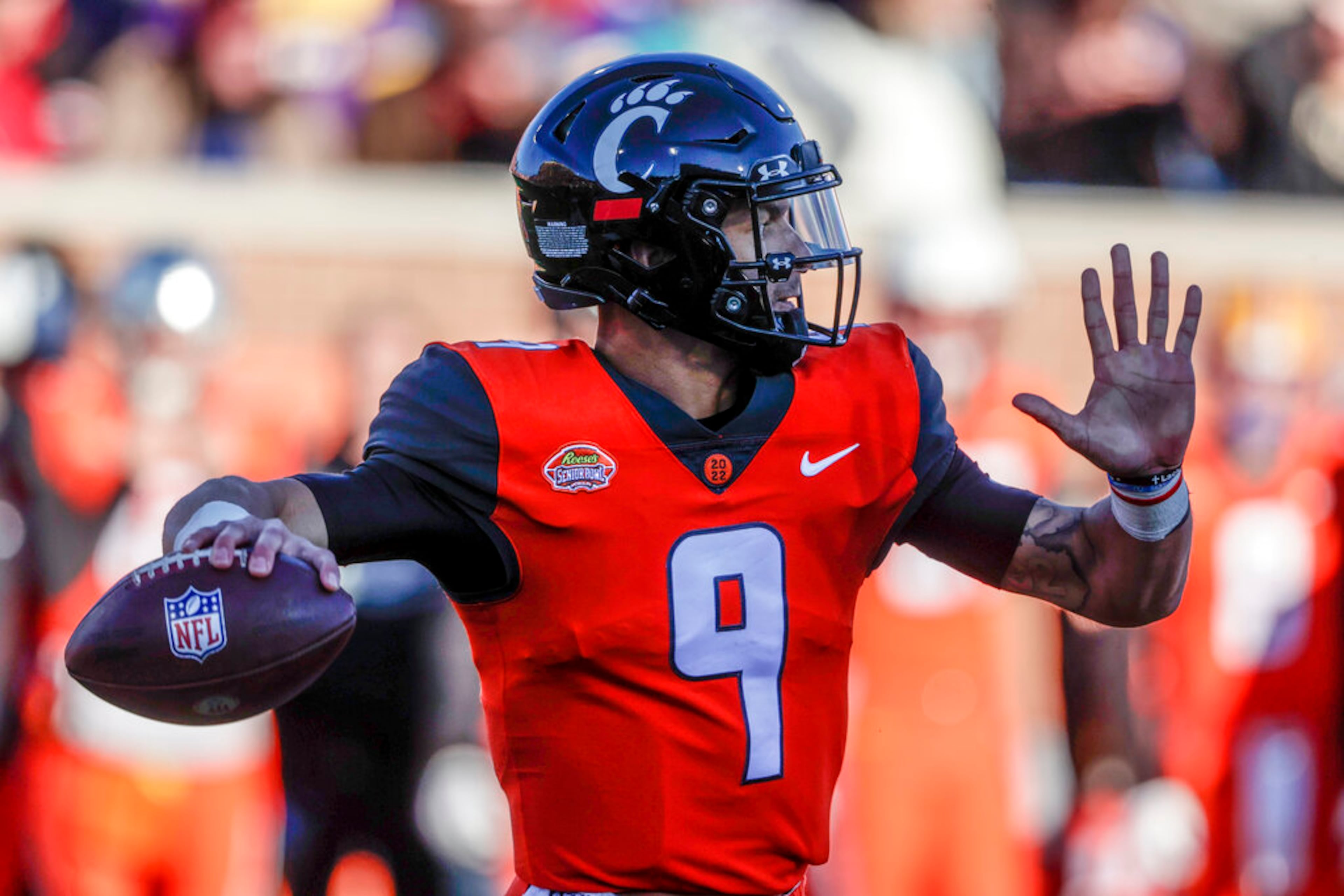 National Team quarterback Desmond Ridder of Cincinnati (9) throws a pass in an NCAA college football game Saturday, Feb. 5, 2022, in Mobile, Ala. (AP Photo/Butch Dill)