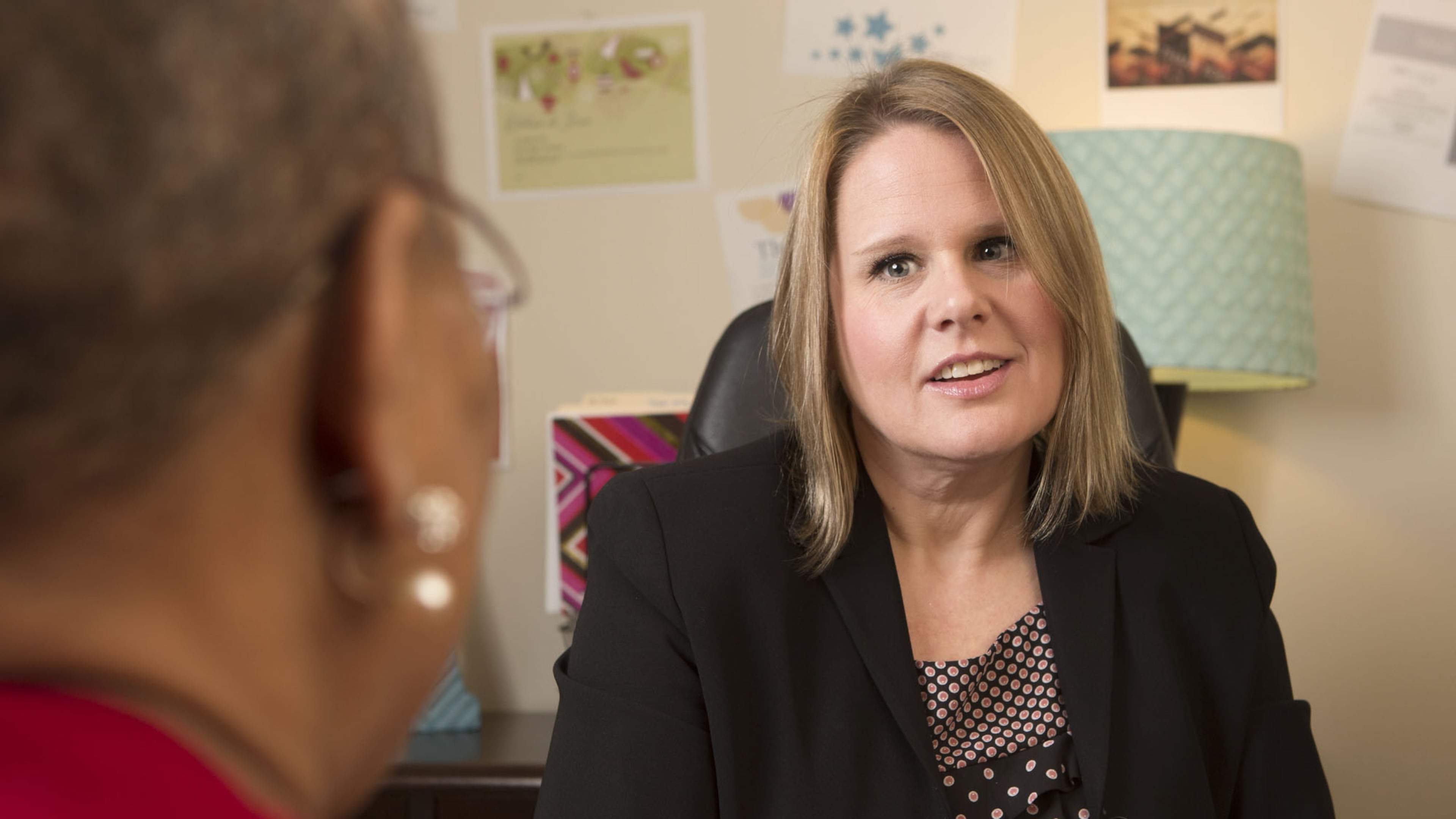 Talent Acquisition Manager Alison Crider talks with colleague Harriett Hamilton in her office at Emory Saint Joseph’s Hospital in Atlanta. Photo by Phil Skinner.