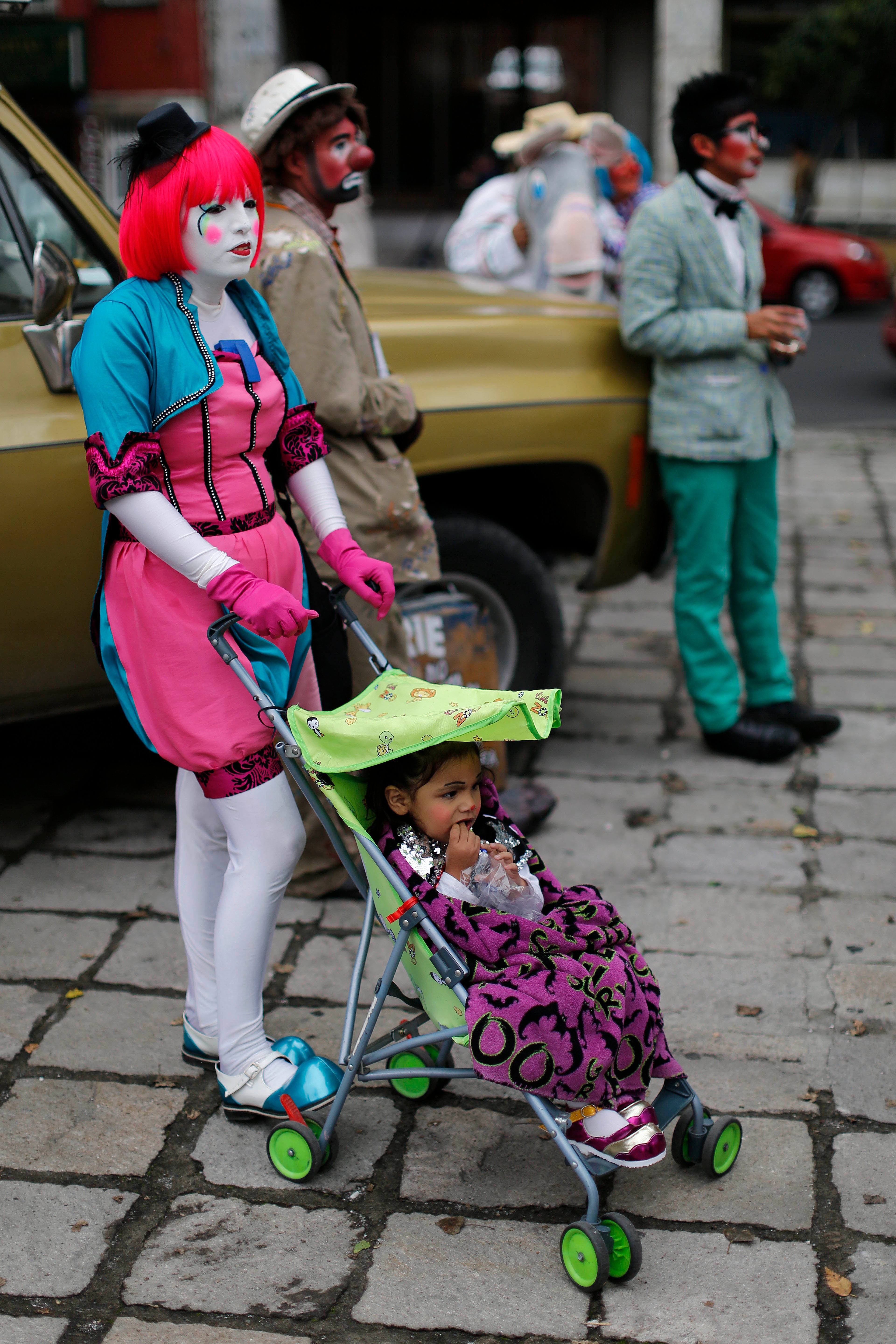 Clowns wait for the start of a laugh-a-thon on the third day of activities at the 17th International Clown Convention in Mexico City, Wednesday, Oct. 23, 2013. They sought a world laugh record but no Guinness official was seen present and they fell short of 15 minutes.