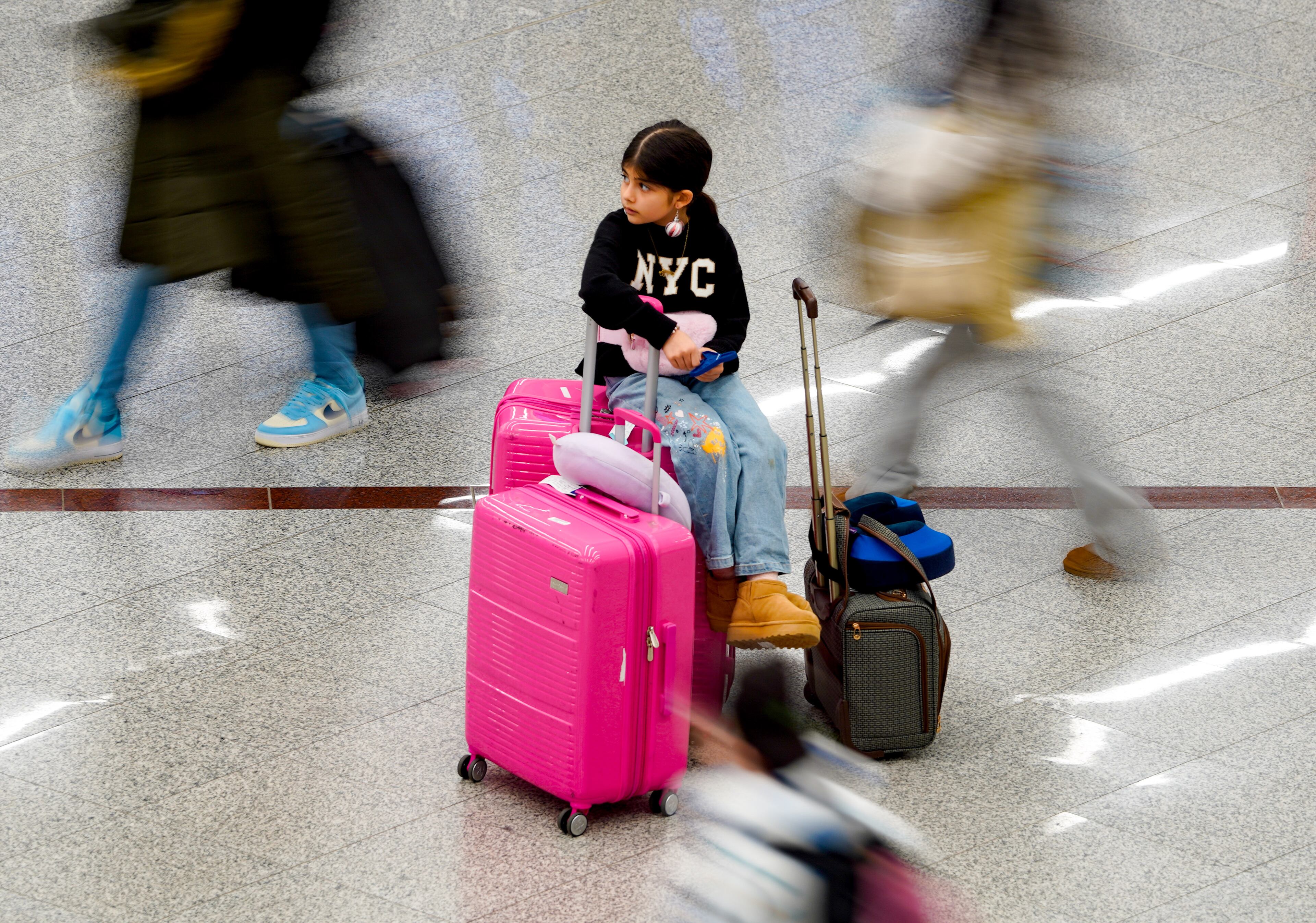 Travelers descend on Hartsfield-Jackson Atlanta International Airport in the final days of the holiday season. Friday, December 20, 2024 (Ben Hendren for the Atlanta Journal-Constitution)