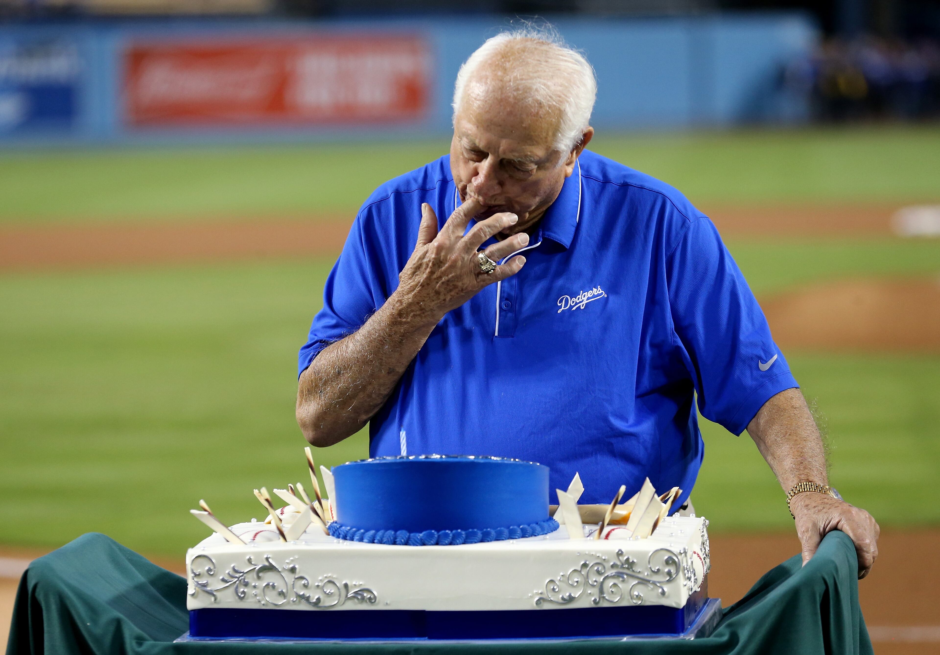 LOS ANGELES, CA - SEPTEMBER 22: Hall of Fame manager and current executive Tommy Lasorda of the Los Angeles Dodgers tastes his cake in a ceremony celebrating his 88th birthday on the field before the game with the Arizona Diamondbacks at Dodger Stadium on September 22, 2015 in Los Angeles, California. (Photo by Stephen Dunn/Getty Images)