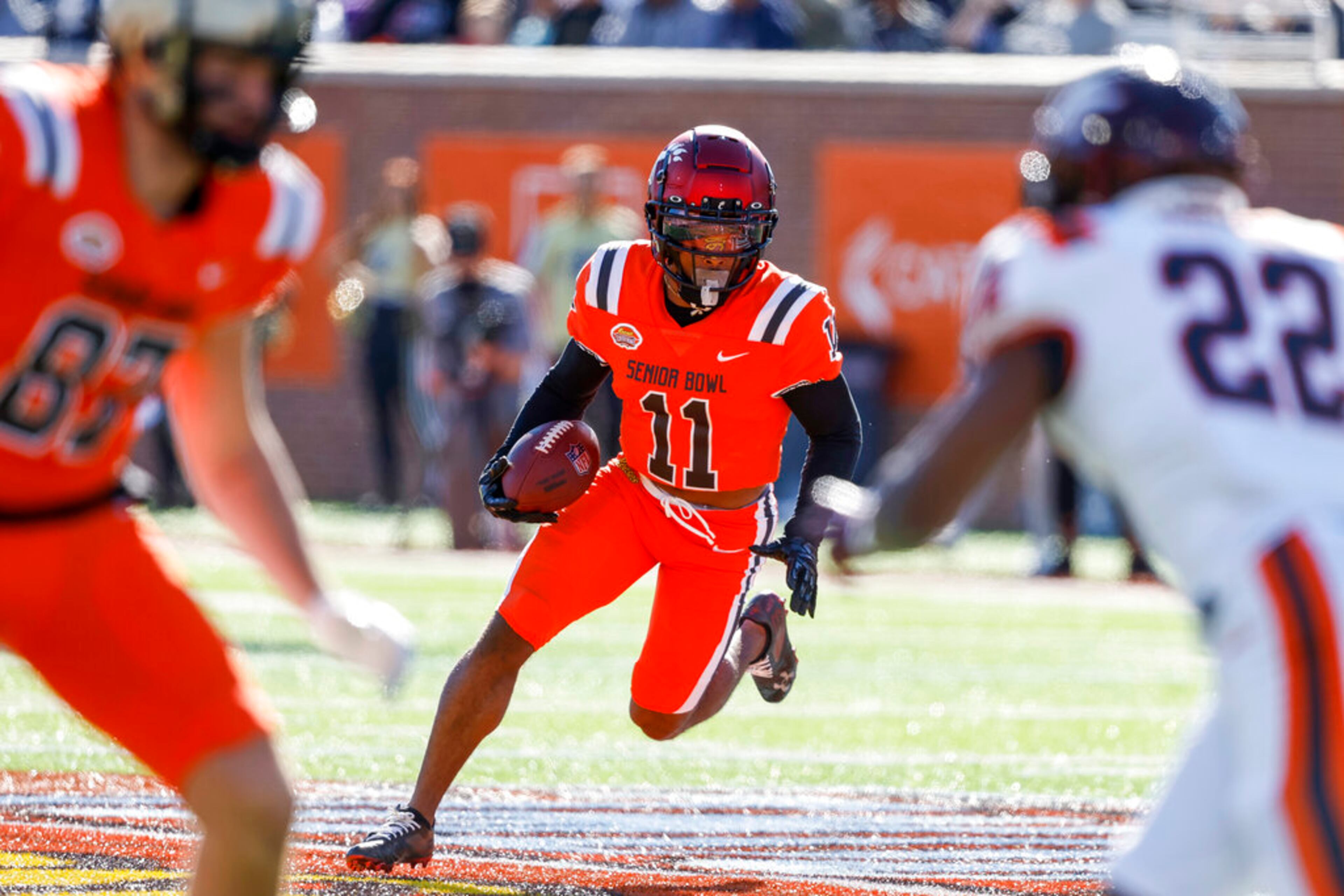 National wide receiver Tre Tucker of Cincinnati (11) carries the ball during the first half of the Senior Bowl NCAA college football game, Saturday, Feb. 4, 2023, in Mobile, Ala.. (AP Photo/Butch Dill)