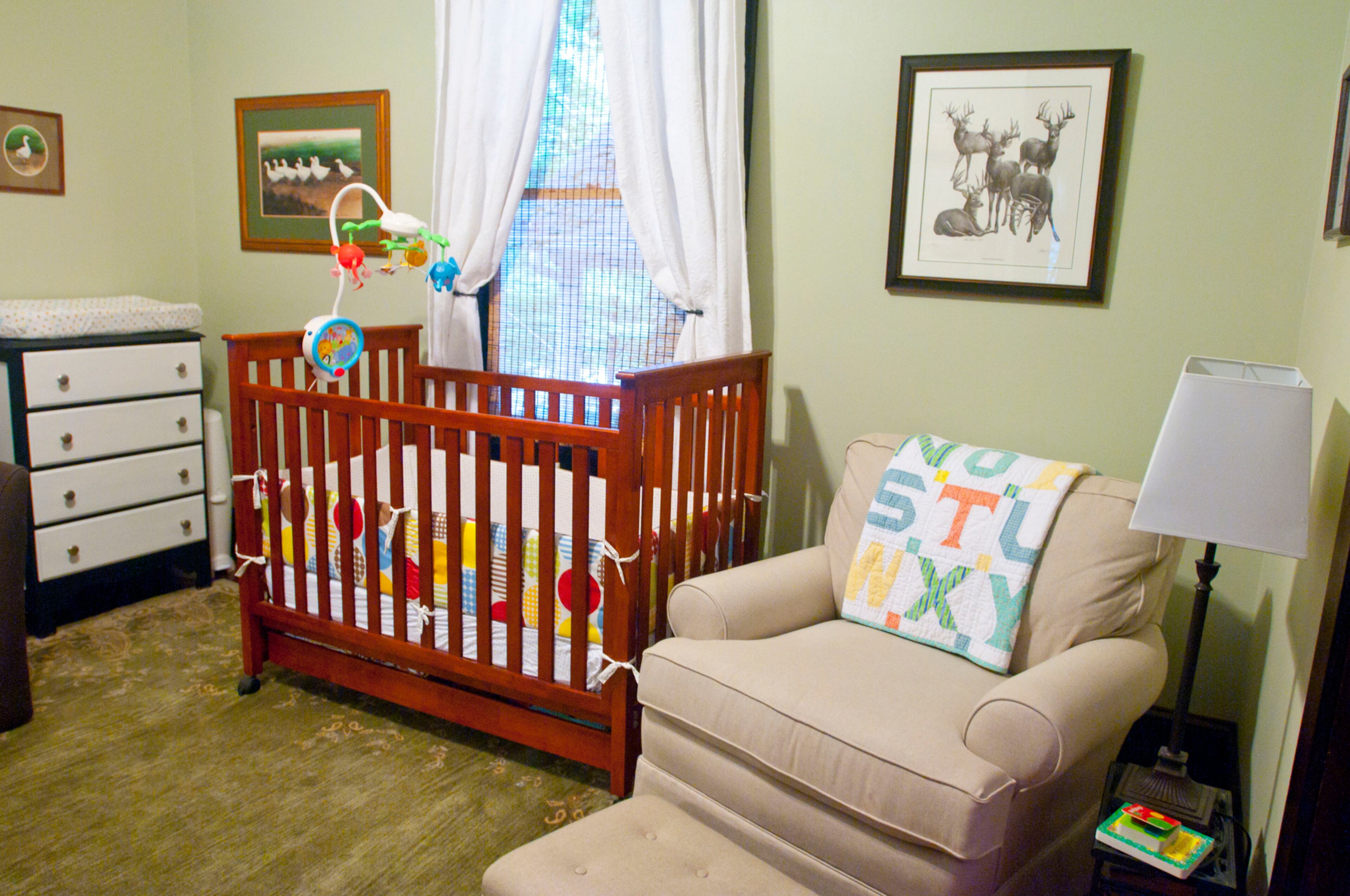 Edie Belle's nursery is light and airy. The paintings in the room were done by family friends and a chair sits next to her crib.