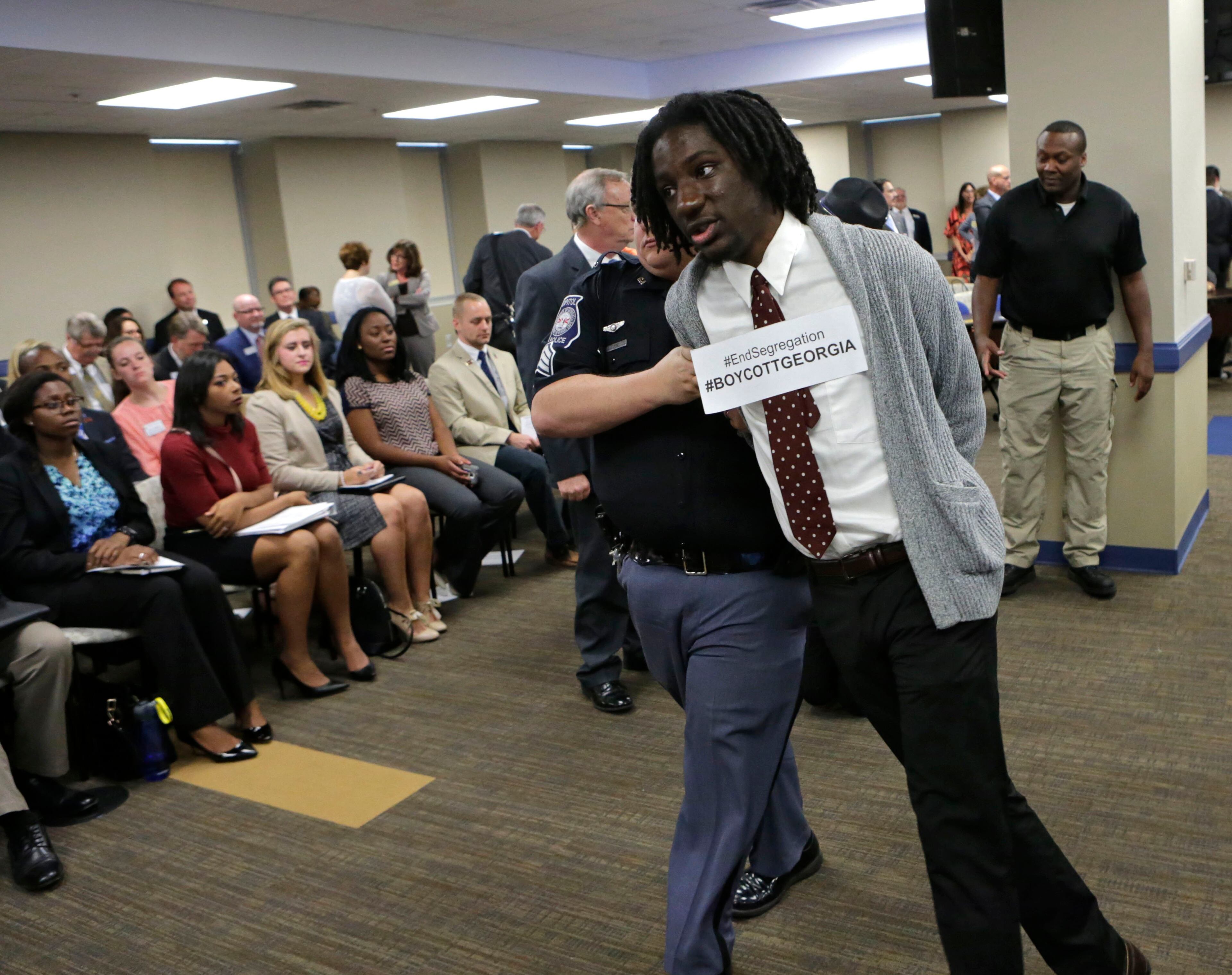 Atlanta - Before this morning's Board of Regents meeting, students protested Georgia's tuition policies that require DACA immigrant students to pay more expensive out-of-state tuition at Georgia's public colleges. A spokesperson for the group said they included students from 7 Georgia colleges and universities. Protestors were arrested when they refused to vacate chairs reserved for the Board of Regents. BOB ANDRES / BANDRES@AJC.COM