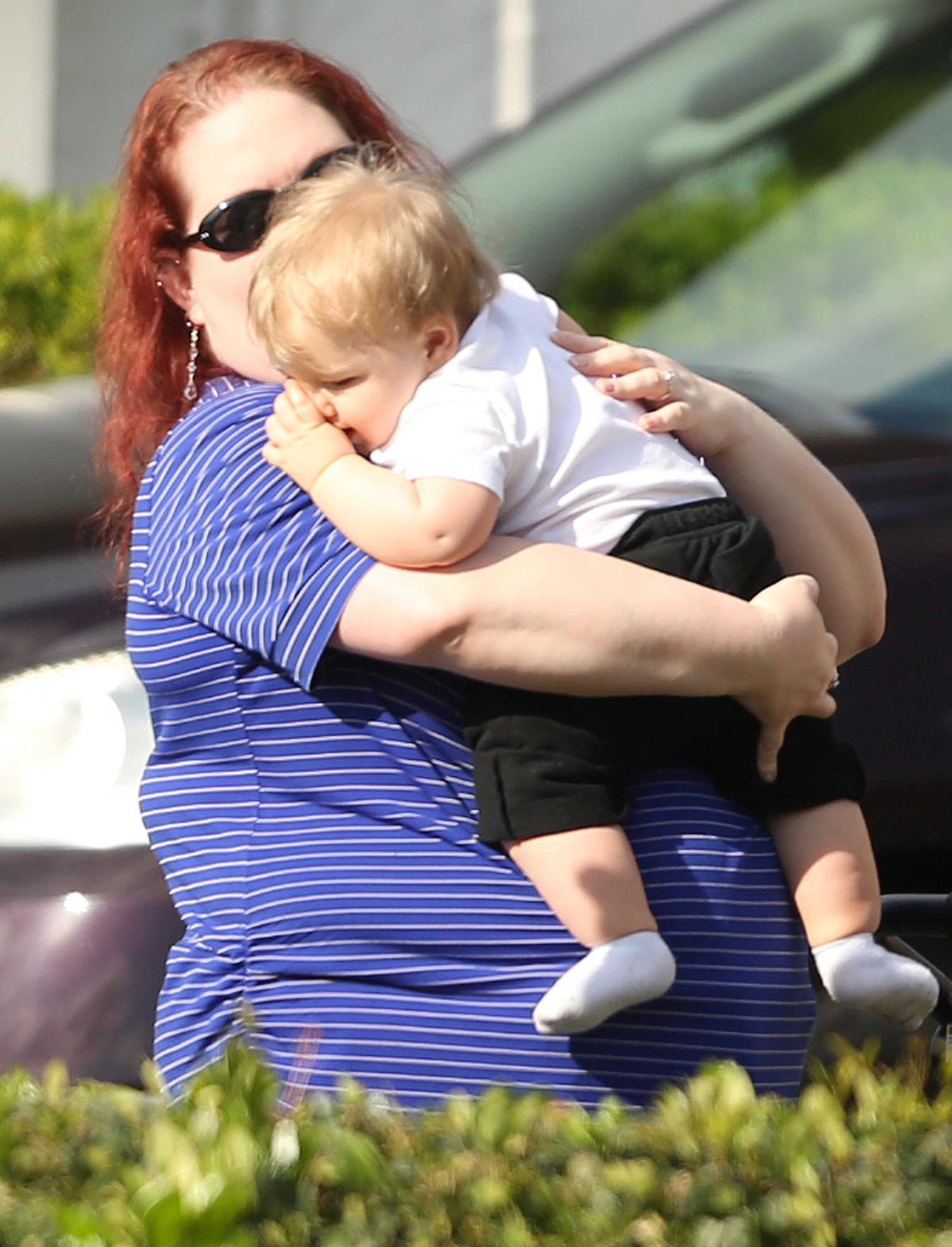 Children are escorted by their parents from the KinderCare Learning Center in Winter Park, Fla., after a car crashed into the facility Wednesday, April 9, 2014. (Stephen M. Dowell, Orlando Sentinel/MCT)